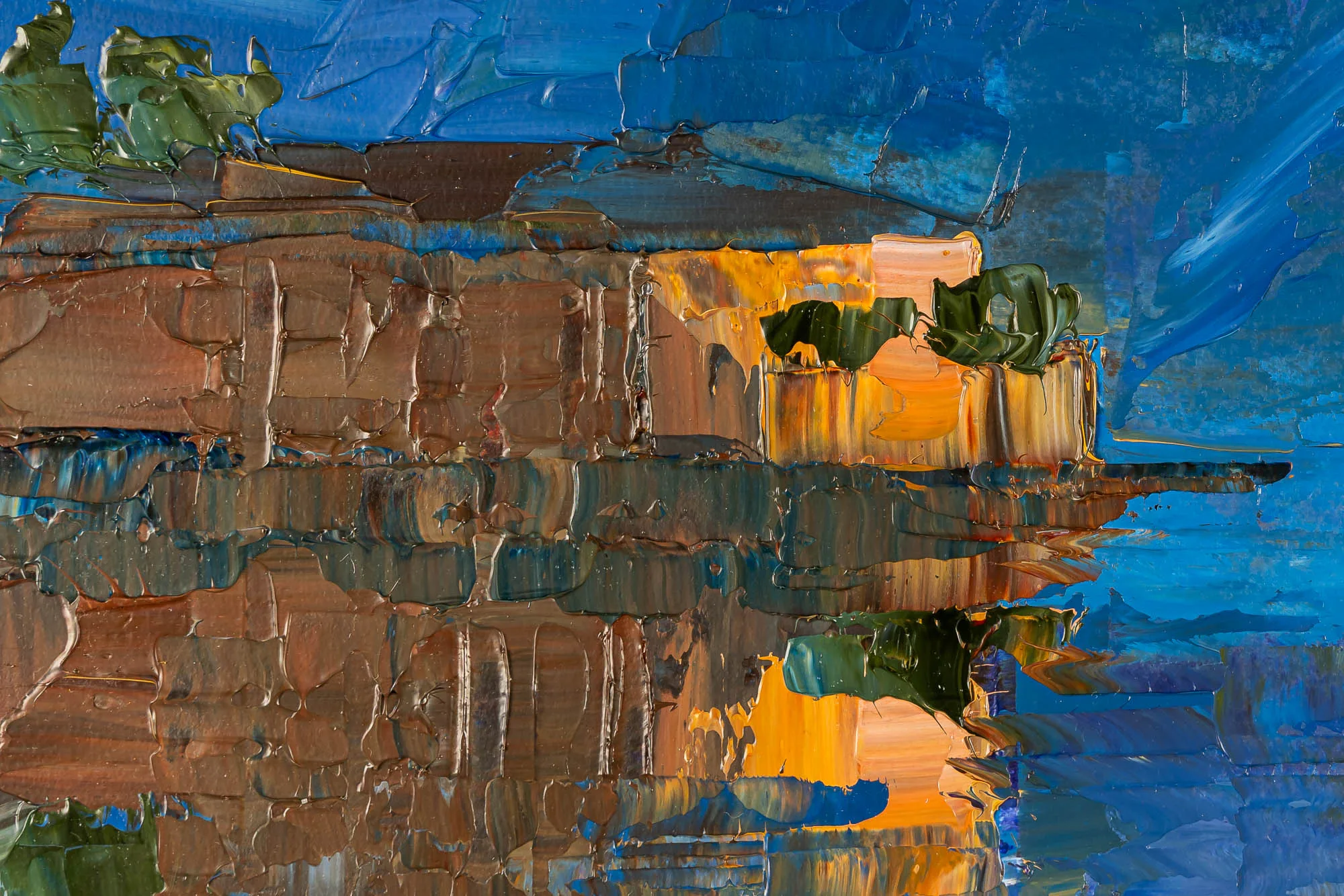 Close-up of Sapphire Reflections, an original painting by Paul Kenton, showing thick textured brown and ochre building forms with green foliage and blue water reflections.