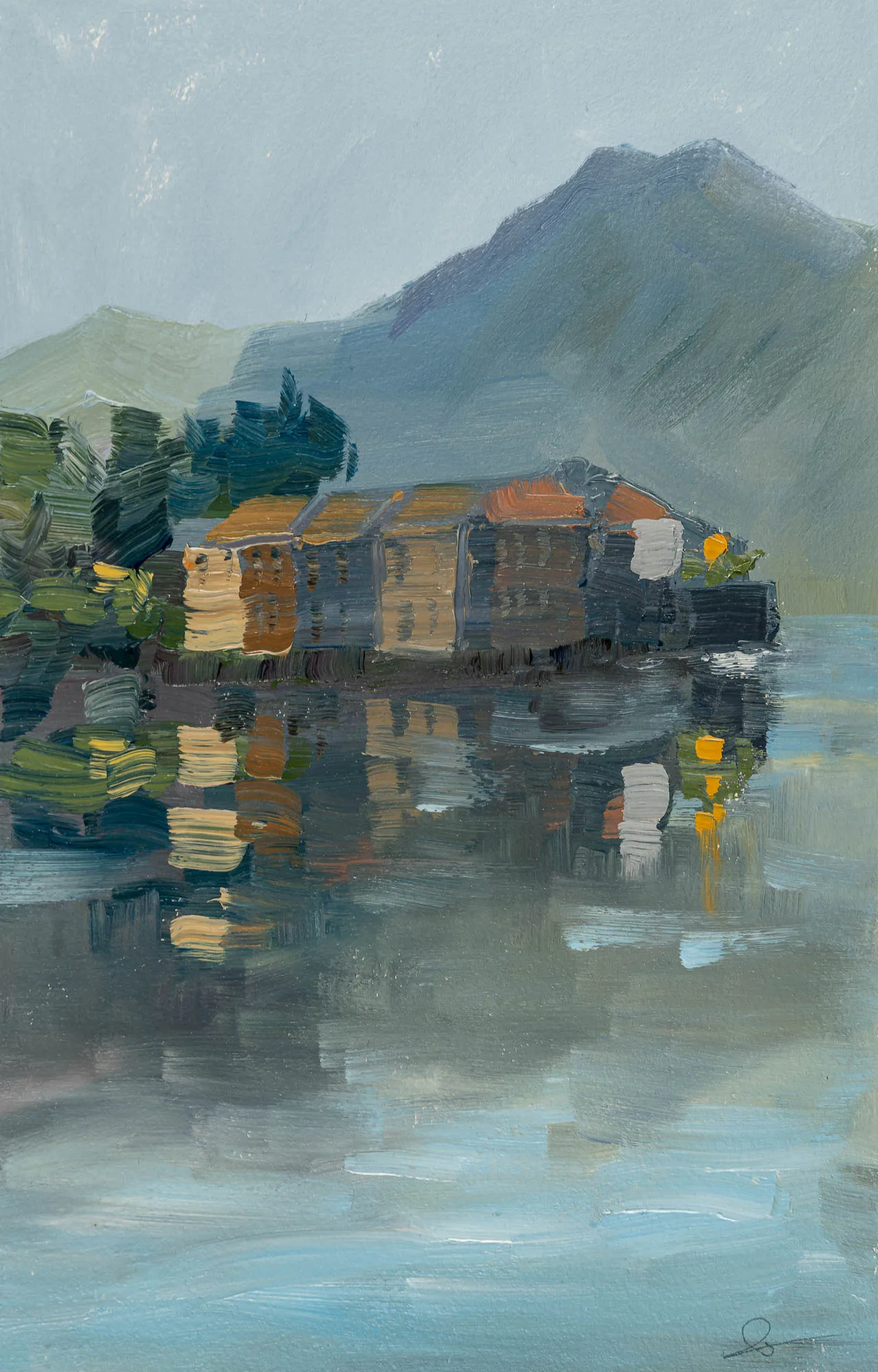 Lakeside Tranquility, an original oil on paper painting by Paul Kenton: a row of textured, ochre and terracotta-roofed houses sits by a misty blue-green mountain, reflected in still water.