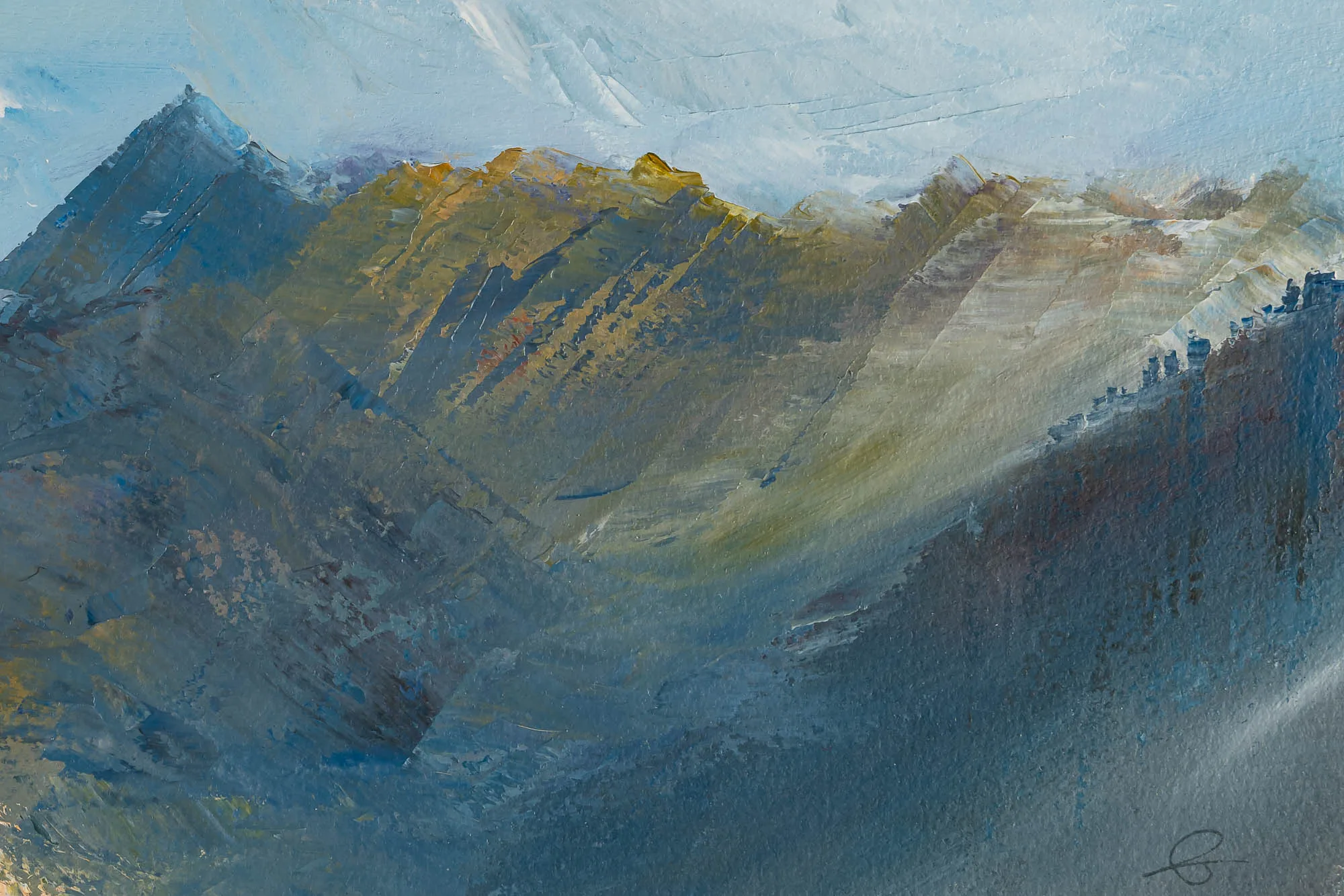 Close-up of Serene Expanse, an original oil on paper painting by Paul Kenton, showing thick, textured brushstrokes of blue, grey and ochre across mountain ridges lit by pale sunlight.