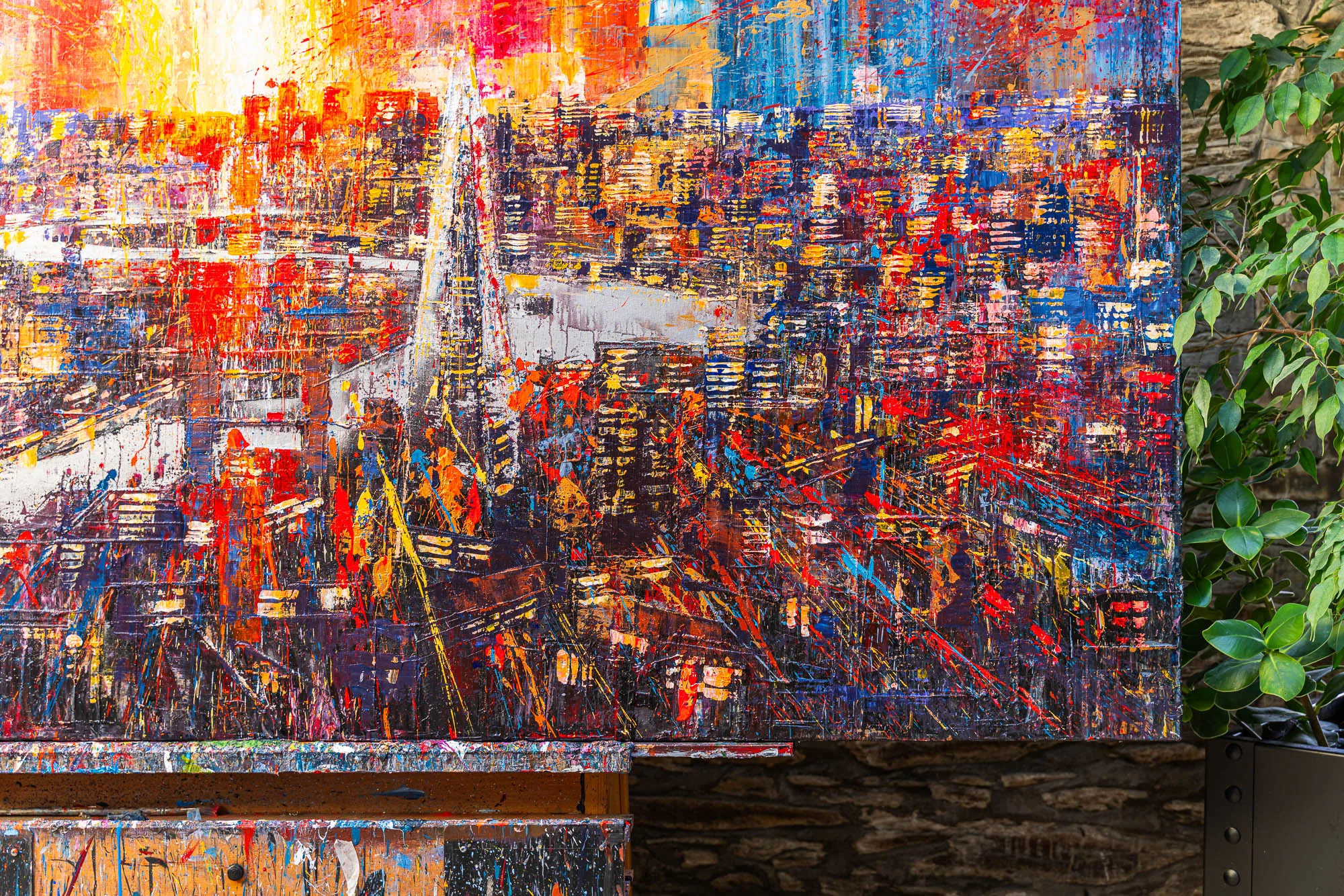 Close-up of Blaze Across the Thames, an original mixed media painting by Paul Kenton, showing a dense, textured London cityscape in fiery reds, oranges and blues, with flecks of metallic paint.