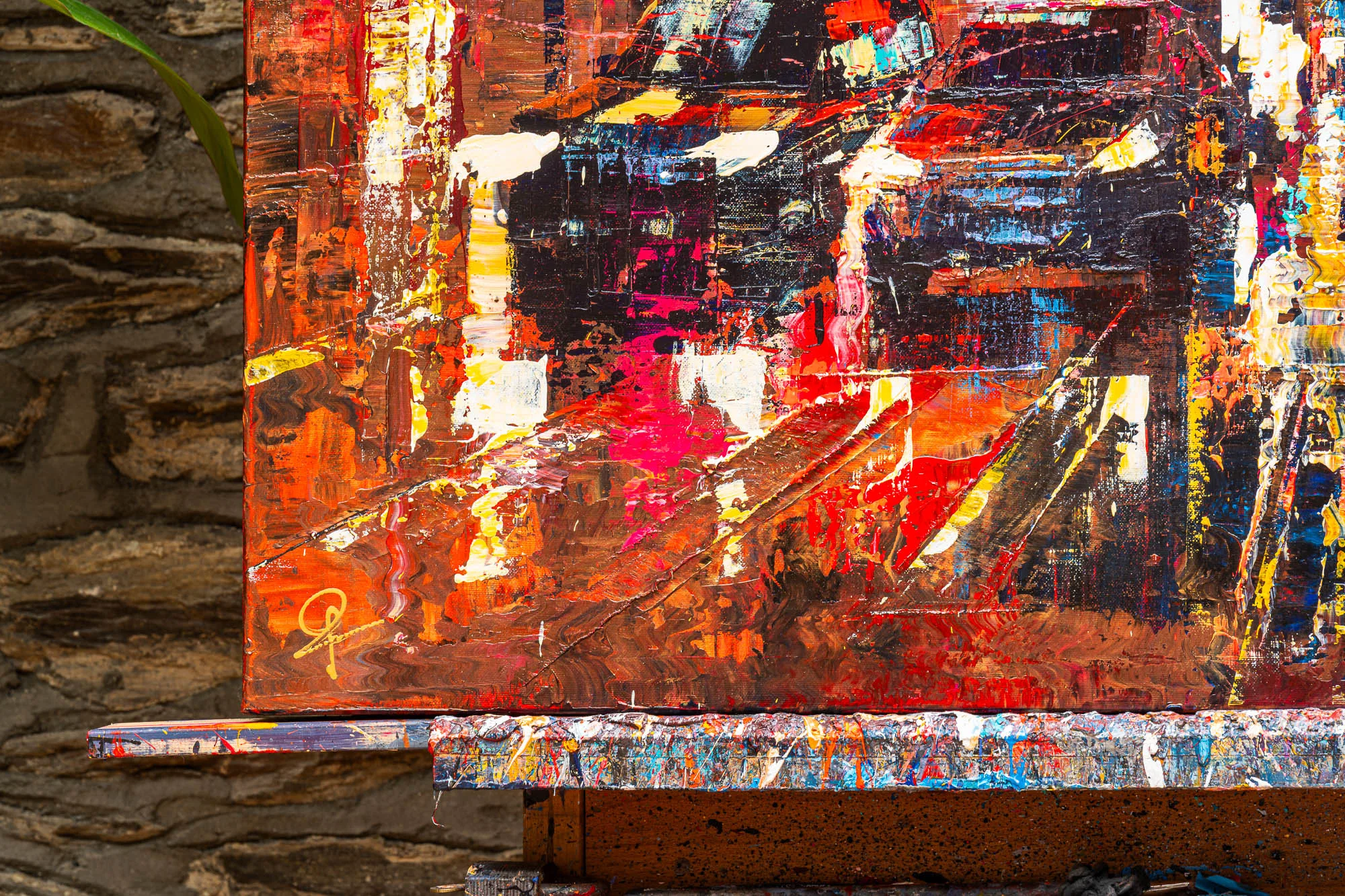 Close-up of Blazing Broadway, an original painting by Paul Kenton, showing thick, textured strokes of red, orange and yellow with black and white accents, suggesting a busy New York street at night.