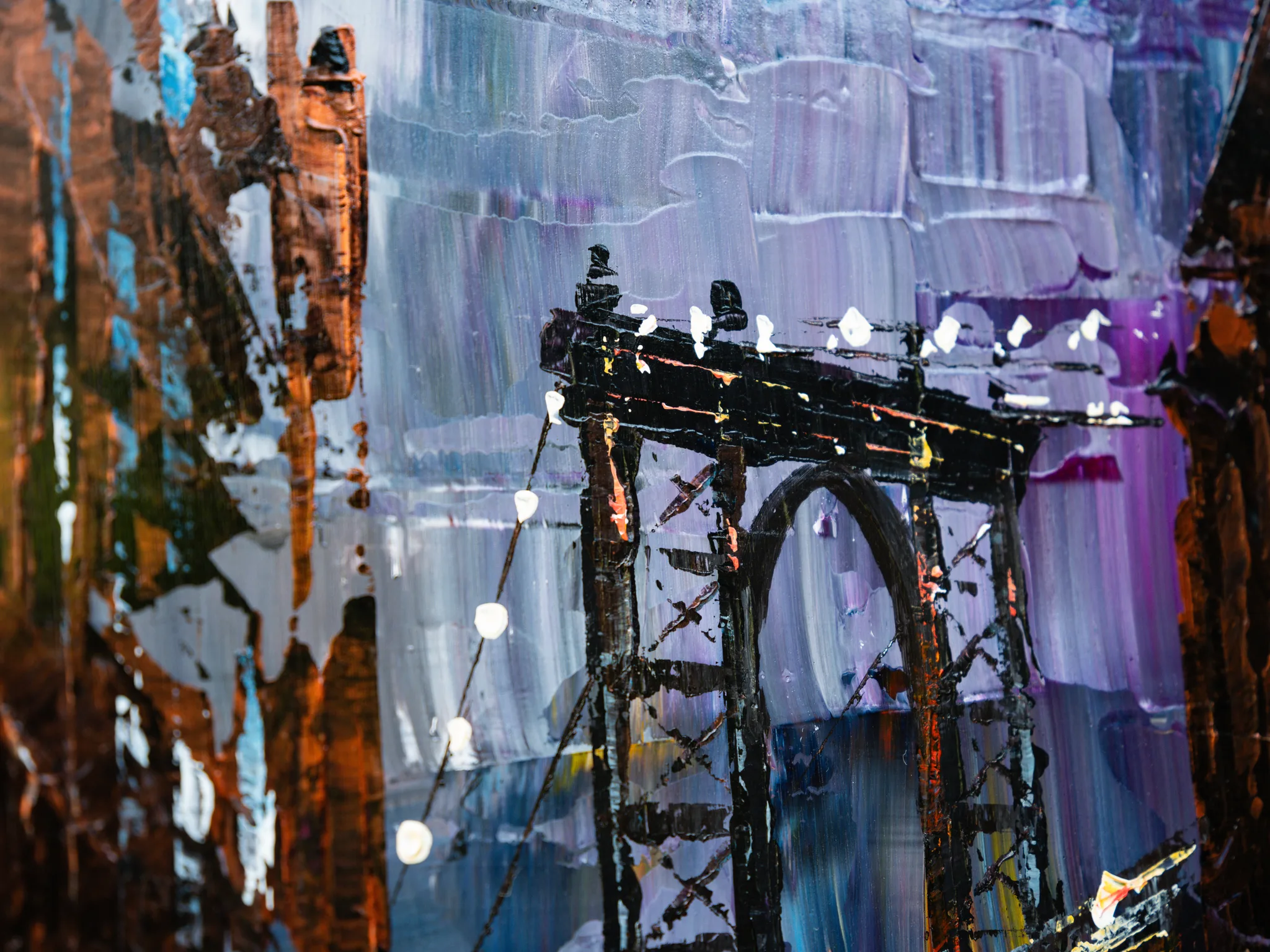 Close-up of Bridge Nocturne by Paul Kenton, showing thick palette-knife strokes of violet, grey and rust forming a dark bridge tower with glowing white lights along its cables.