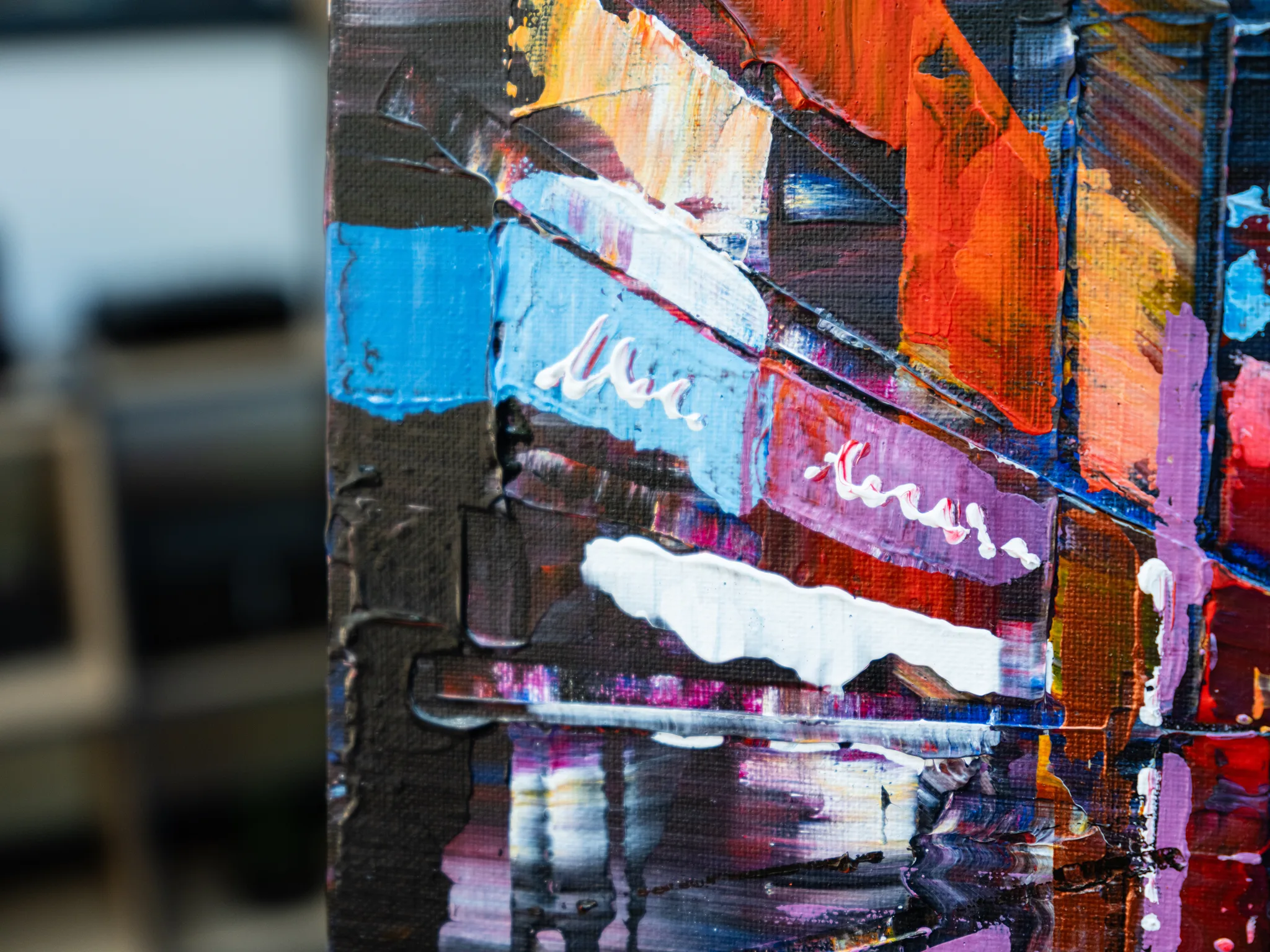 Close-up of City Corridor, an original painting by Paul Kenton, showing thick textured brushstrokes of orange, blue, pink and white forming abstracted New York street scenes with glowing reflections.