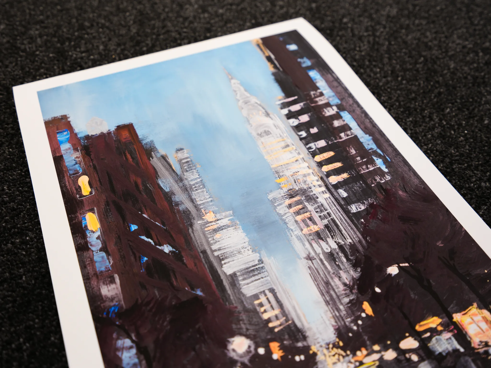 Close-up of Chrysler Shines, a limited edition print: the Chrysler Building's spire rises through textured brushwork under a pale blue sky.