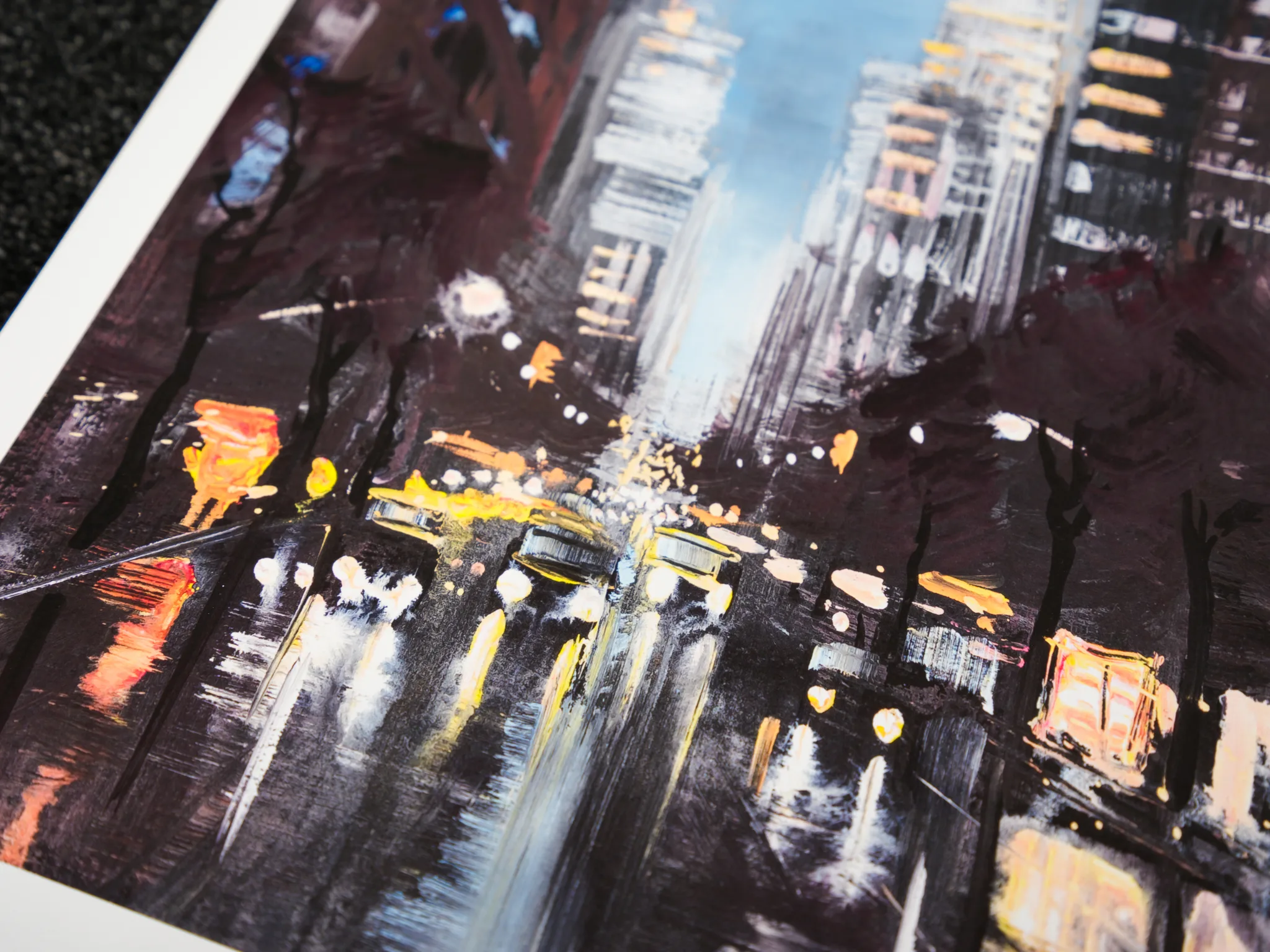Close-up of Chrysler Shines, a limited edition giclée print, showing a night street scene with yellow taxi lights, glowing windows and tall blurred towers in dark browns and blues.