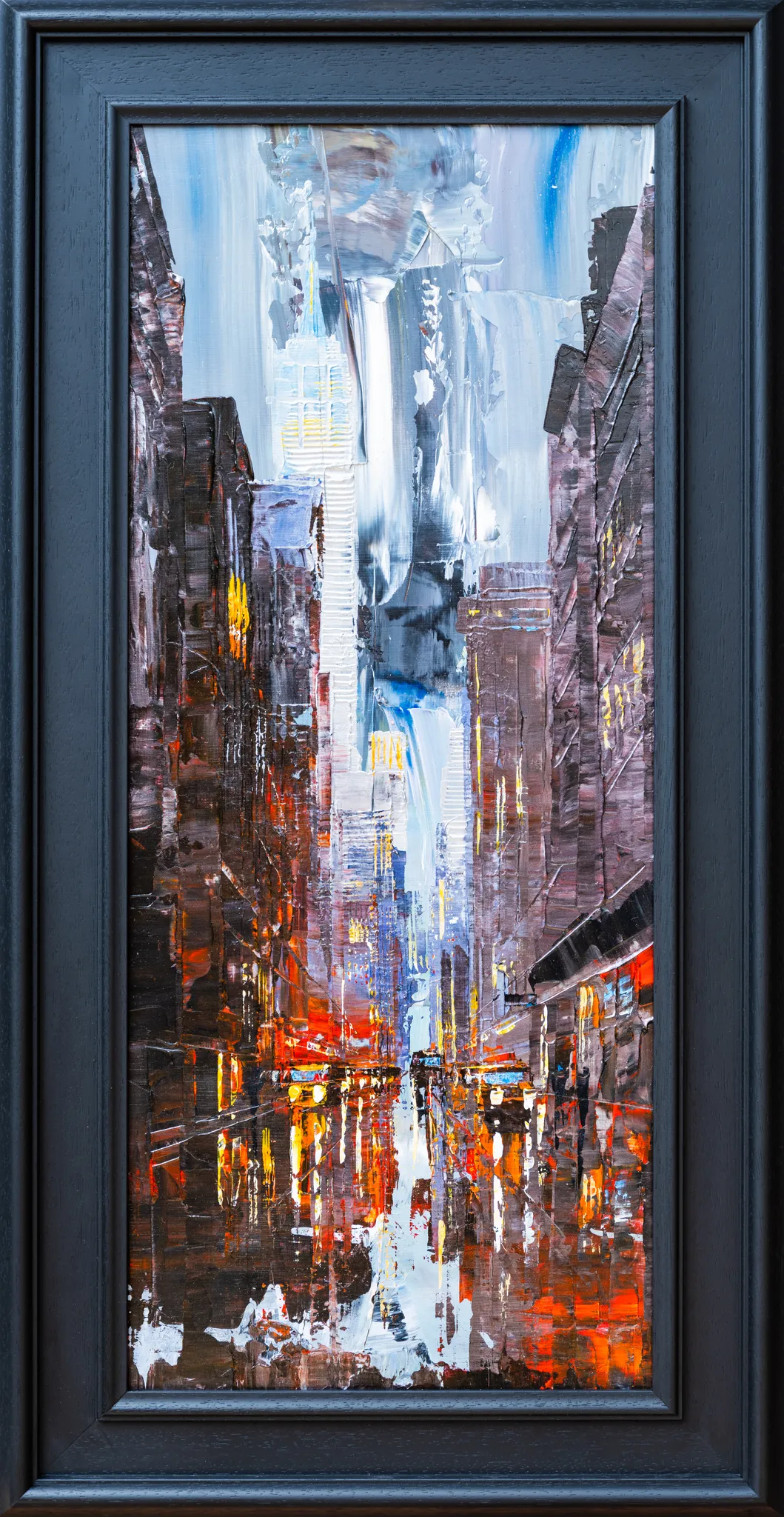 Dark Midtown, an original painting by Paul Kenton in a dark navy frame: a narrow New York street at dusk, with towering buildings, a pale tower ahead, and red and orange reflections on wet ground.