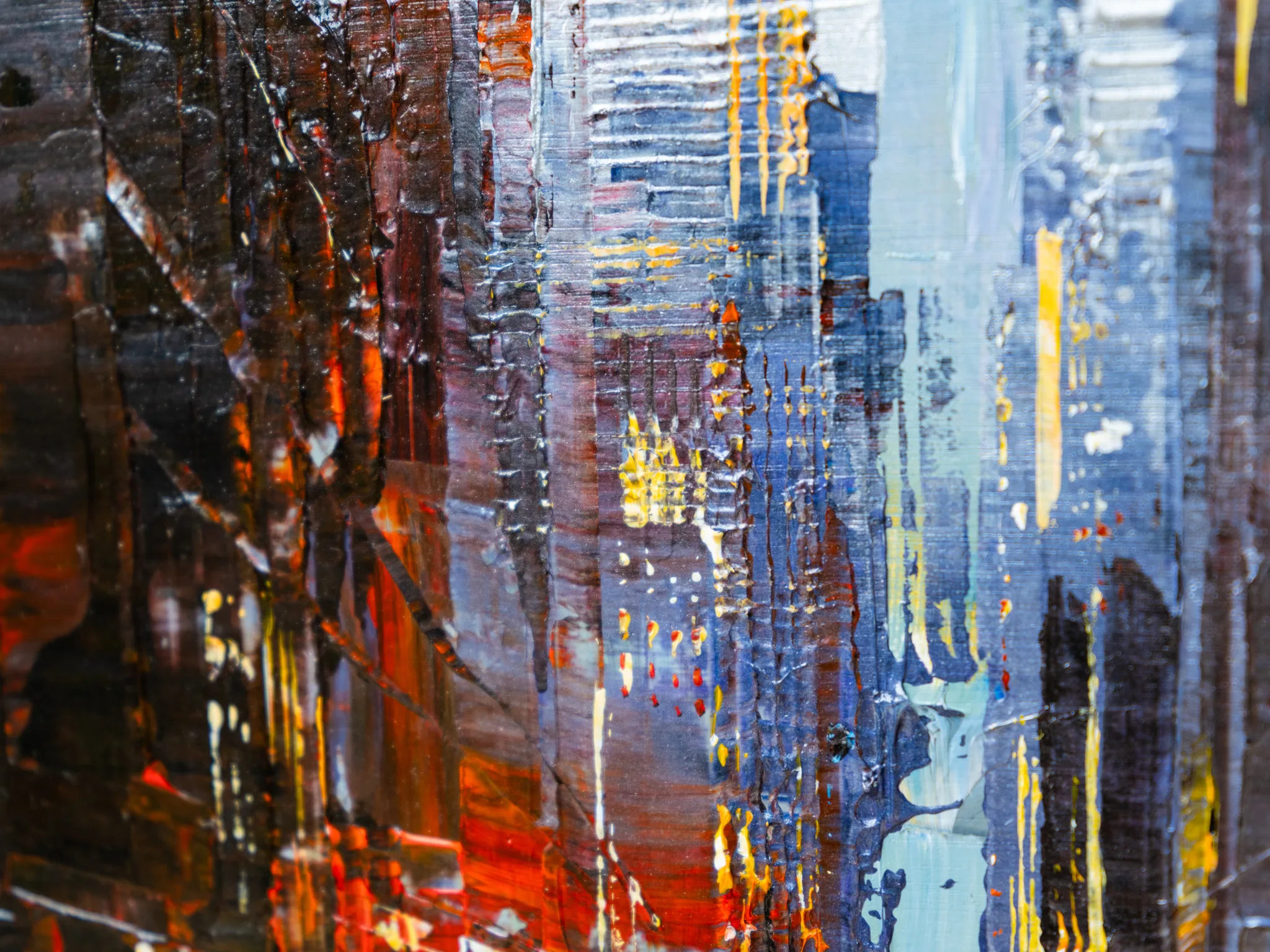 Close-up of Dark Midtown, an original painting by Paul Kenton: thick, textured strokes of rust, navy and charcoal with flecks of gold and drips of yellow suggest towering New York buildings at dusk.