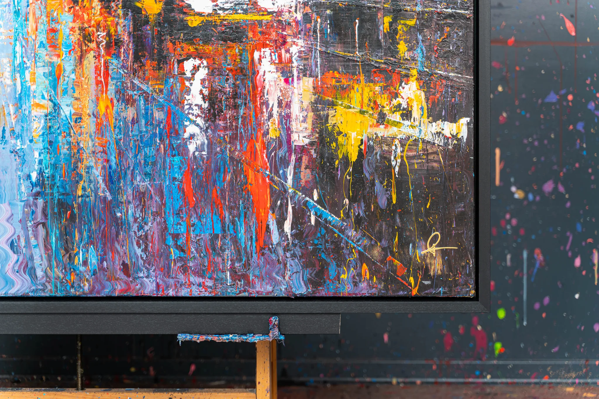 Close-up of Empire City Spectrum, an original mixed media painting by Paul Kenton, showing thick drips of blue, orange, yellow and white over a dark textured ground.