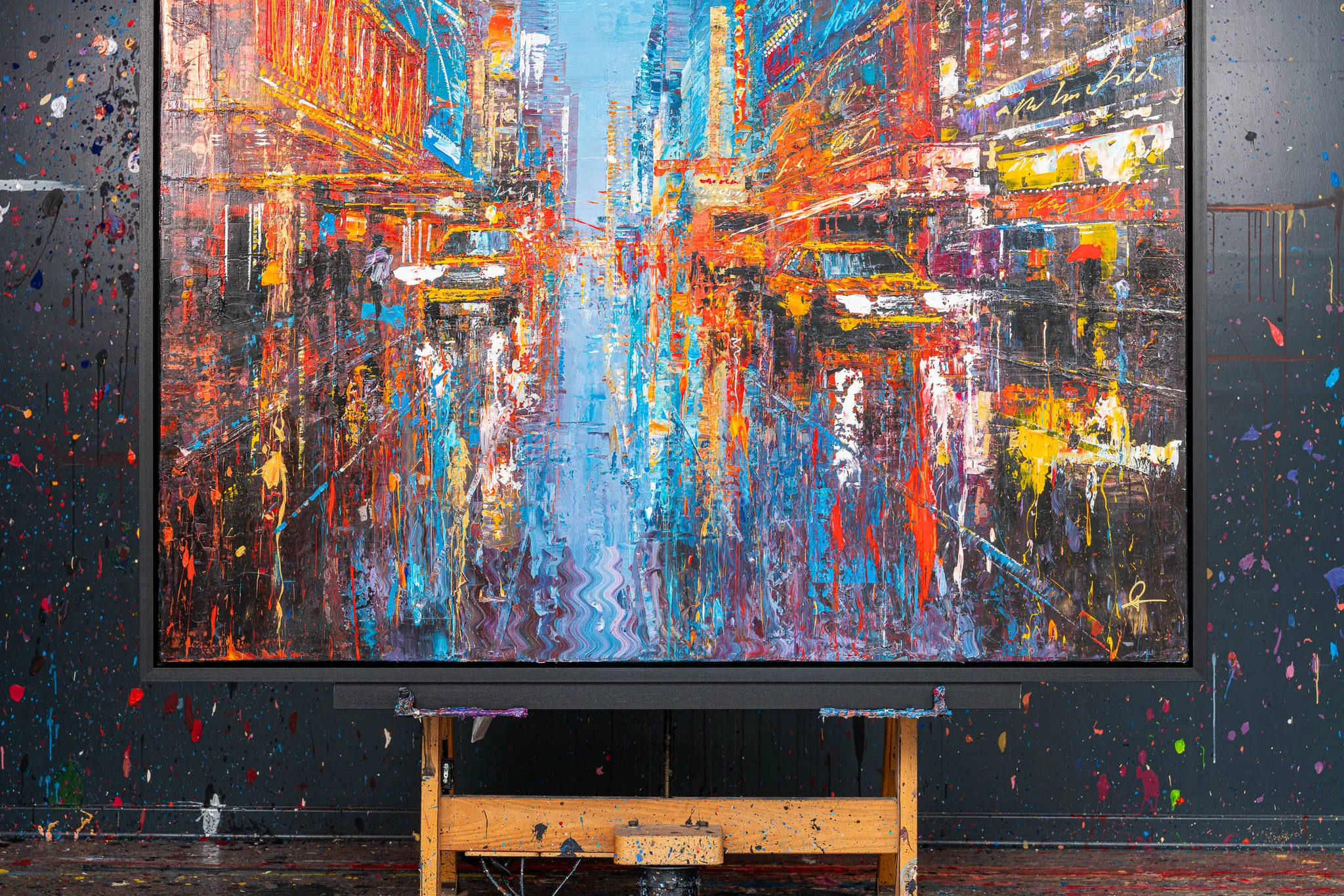 Close-up of Empire City Spectrum, an original mixed media painting by Paul Kenton of a New York street at night, with thick, textured strokes of red, orange, blue and gold.