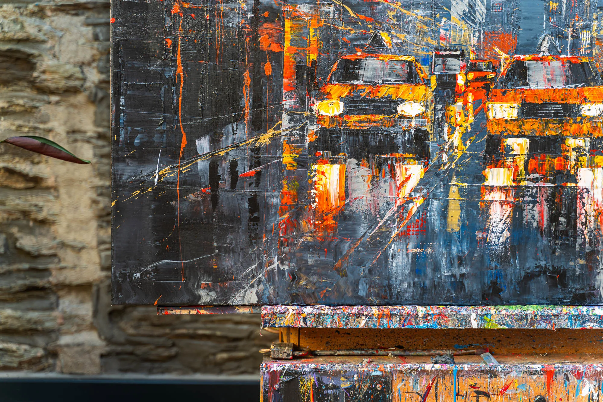Close-up of Flight Of The Taxis, an original painting by Paul Kenton, showing thick textured strokes of orange and yellow headlights and cabs glowing against dark grey New York streets.