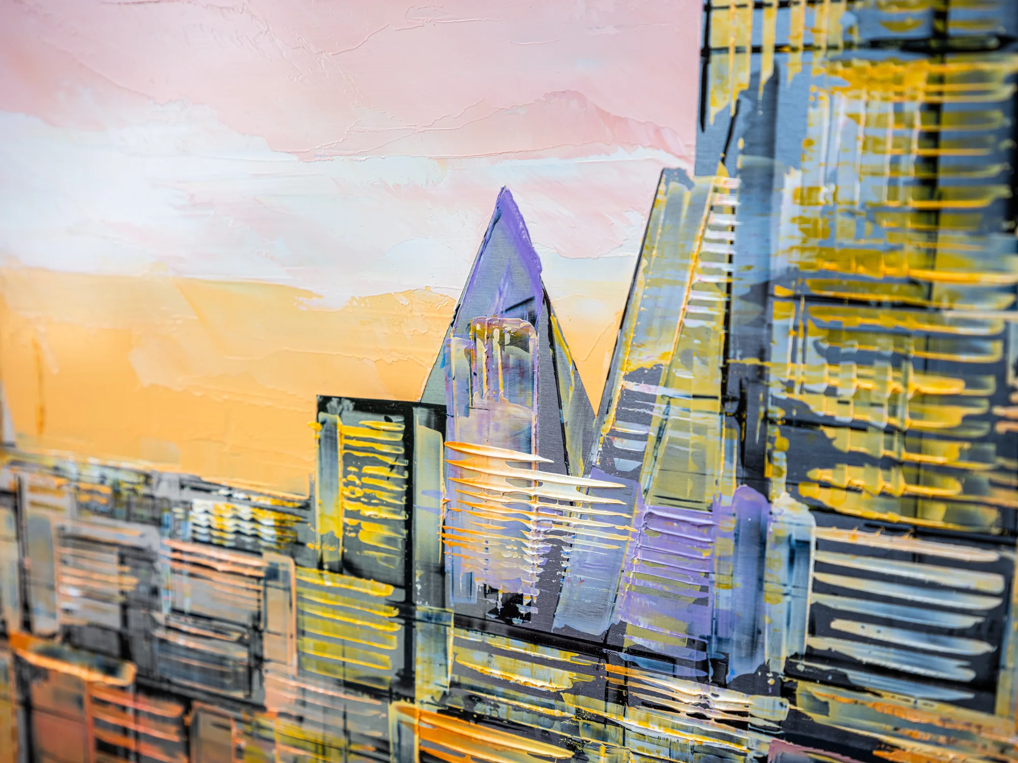 Close-up of Golden Capital, an original painting by Paul Kenton, showing thick textured brushwork on angular towers of London's skyline against a pink and orange sunset.