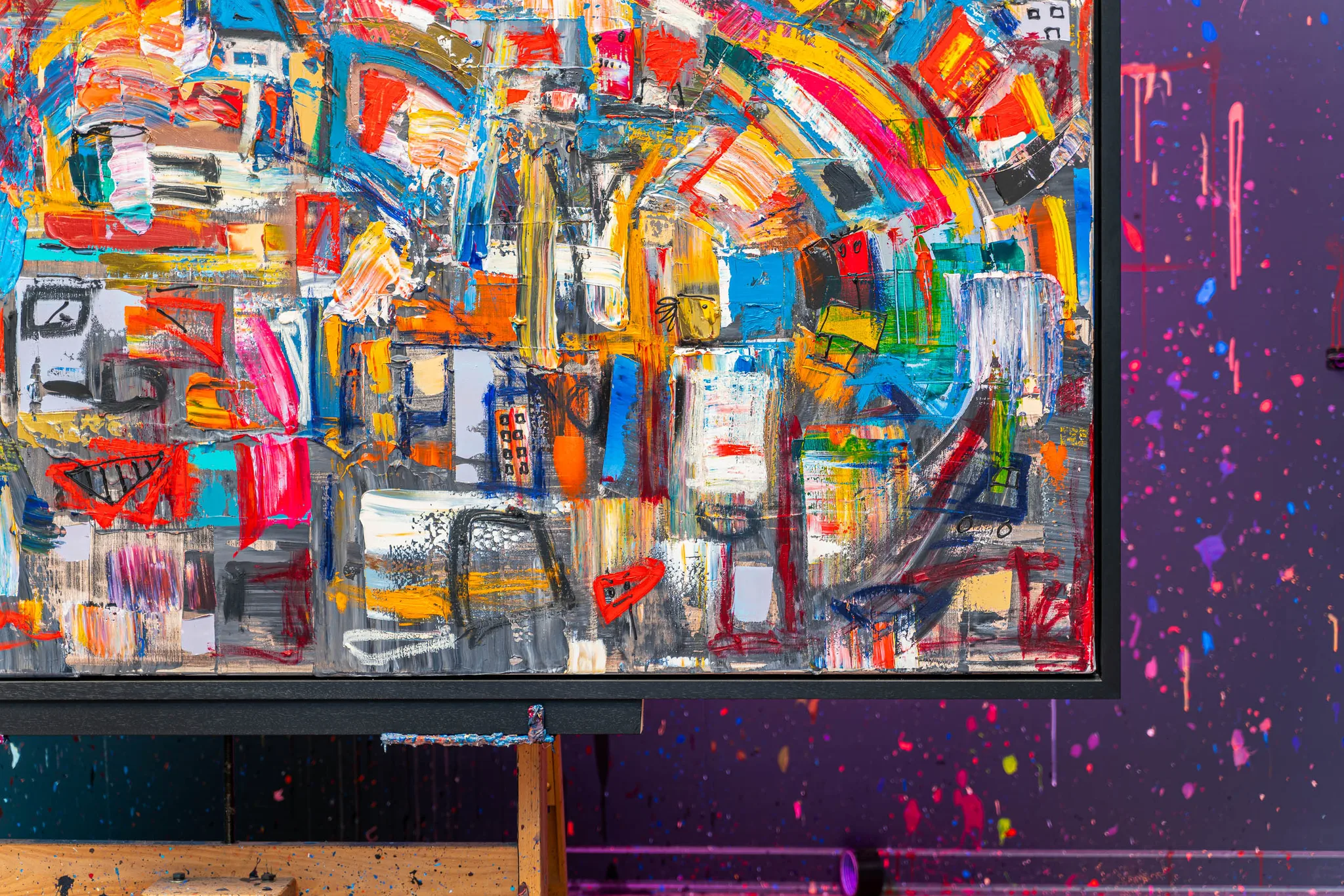 Close-up of Laid Back, an original mixed media painting by Paul Kenton, showing thick, energetic brushstrokes in red, orange, blue and yellow over grey, with dark linear marks and a splattered purple wall behind.