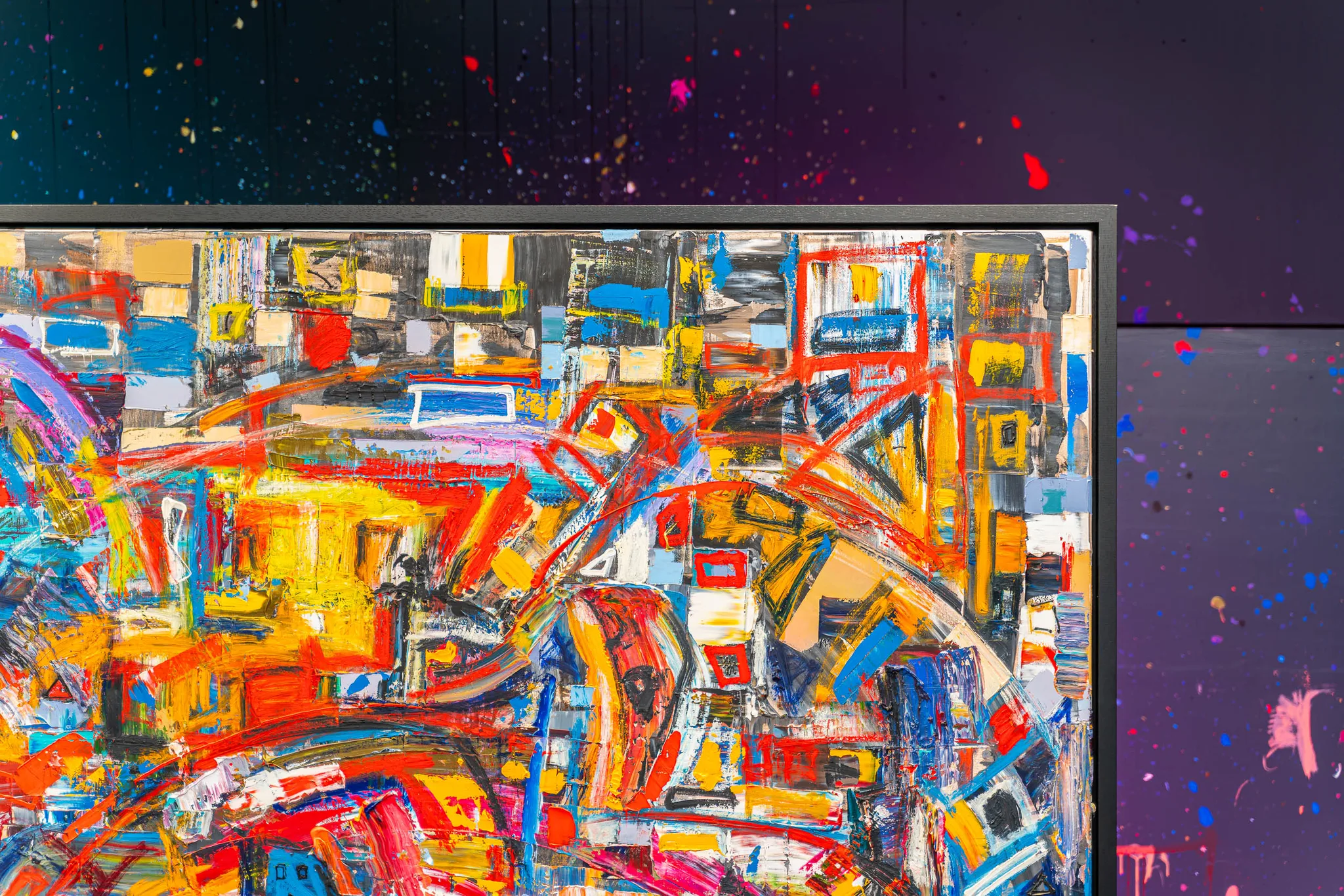 Close-up of Laid Back, an original painting by Paul Kenton, showing dense, energetic brushwork in red, yellow, blue and orange over rectangular blocks of colour, with a dark frame edge and splattered backdrop.