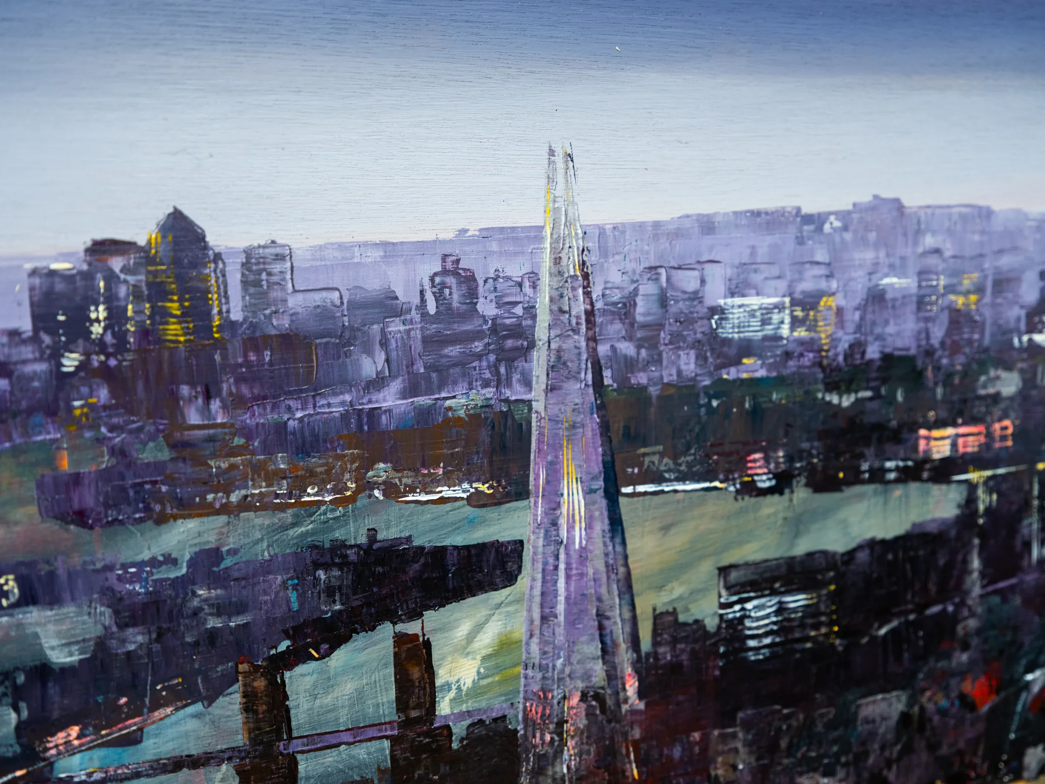Close-up of London Nocturne by Paul Kenton, showing a tall, spiky tower rising from a textured dusk skyline of violet, grey and green, with brushy strokes and glints of gold light.