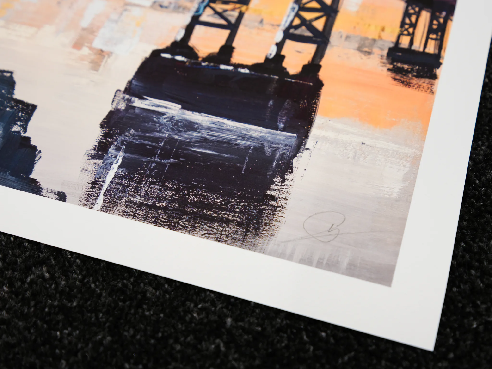 Close-up of the lower corner of Manhattan Bridge Splendour, a limited edition print by Paul Kenton, showing dark textured brushstrokes of a bridge pier against warm orange and pale grey, with the white paper border.