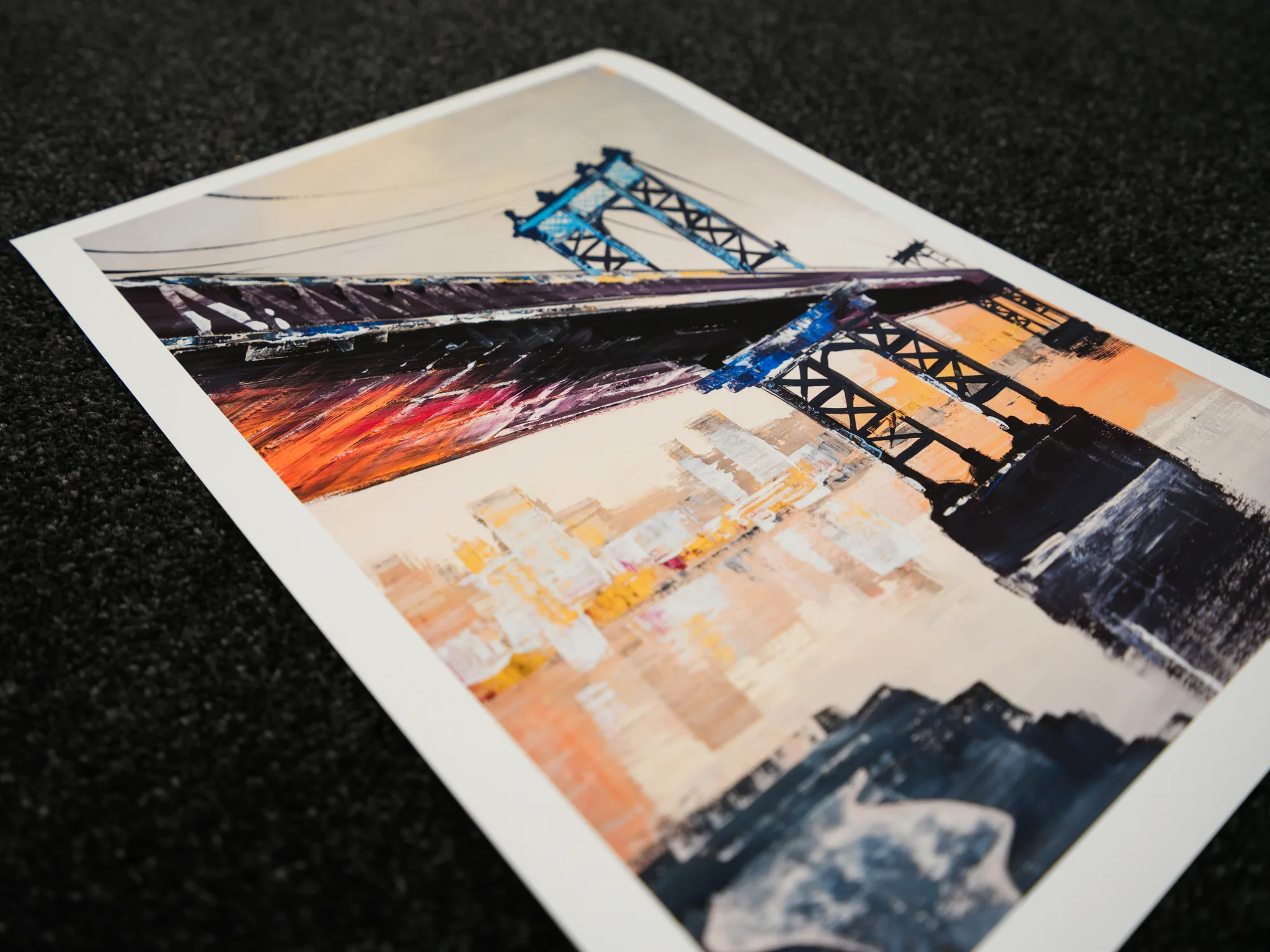 Detail of Manhattan Bridge Splendour, a limited edition giclée print by Paul Kenton, showing a bridge's blue and black steel towers and cables above a hazy, textured cityscape in orange, yellow and cream.