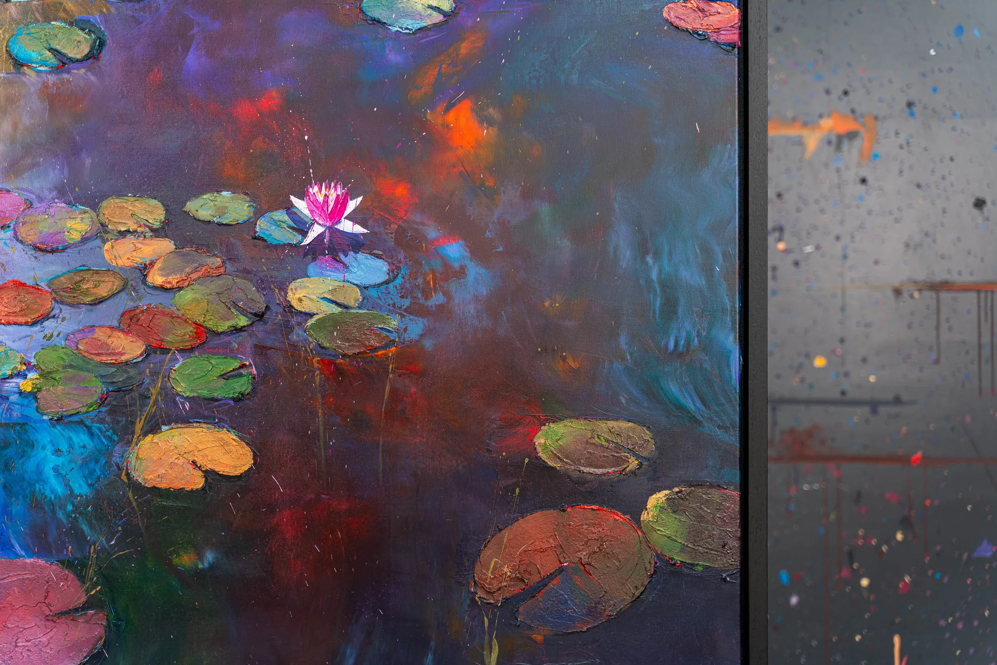 Close-up of Nocturne Blossoms, an original painting by Paul Kenton: thickly textured water lily pads in green, orange and red float on a dark violet pond, with a single pink blossom and streaks of metallic sheen.