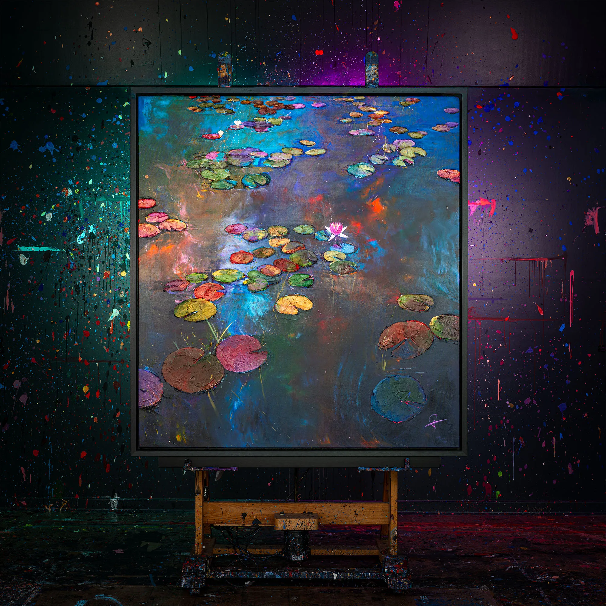 Nocturne Blossoms, an original mixed media painting by Paul Kenton, shown on a wooden easel in a paint-splattered studio. Thick, textured lily pads and a pink water lily float on a shimmering blue and violet pond.