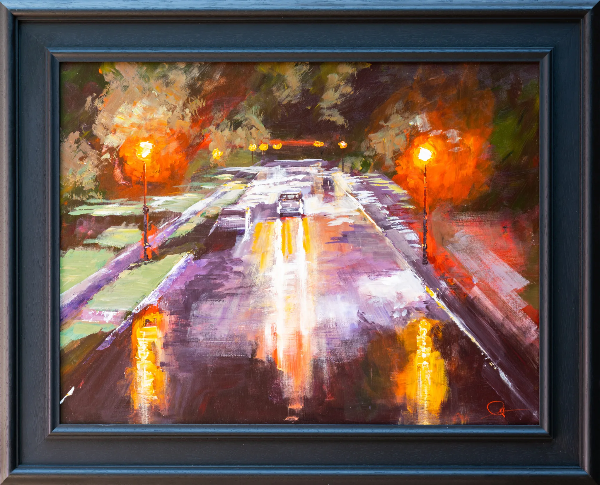 Night Drive, an original painting by Paul Kenton, shown in a dark blue wooden frame: a rain-slicked city road at night, lit by glowing orange street lamps and warm reflections.