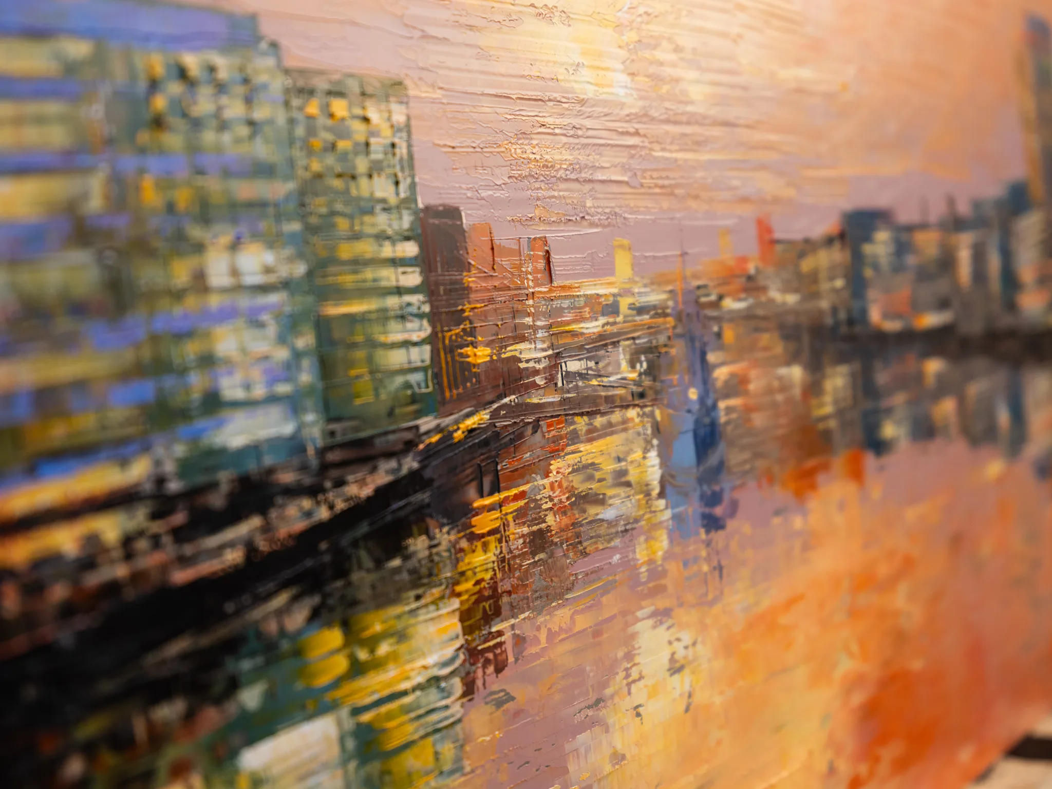Close-up of Reflections on the Thames, an original painting by Paul Kenton, showing thick textured brushstrokes of city towers reflected in water beneath a glowing orange and pink sunset sky.