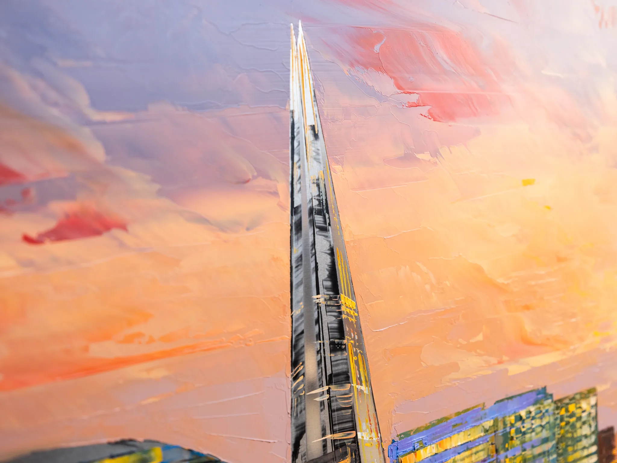 Close-up of Reflections on the Thames, an original painting by Paul Kenton: a thick-textured spire of The Shard rises against a pink and orange sunset sky, with blue and yellow buildings at the bottom edge.