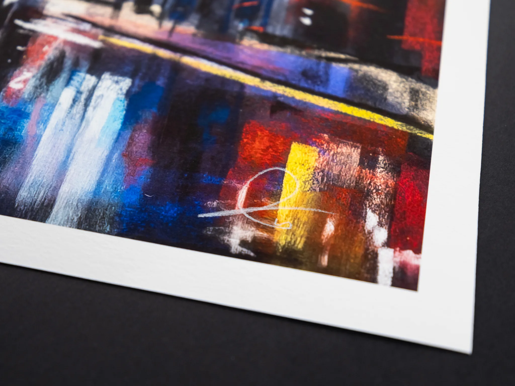 Close-up of a corner of the St Paul's Star limited edition giclée print on white paper, showing textured blue, red and yellow city-night brushwork with a pale circular line.