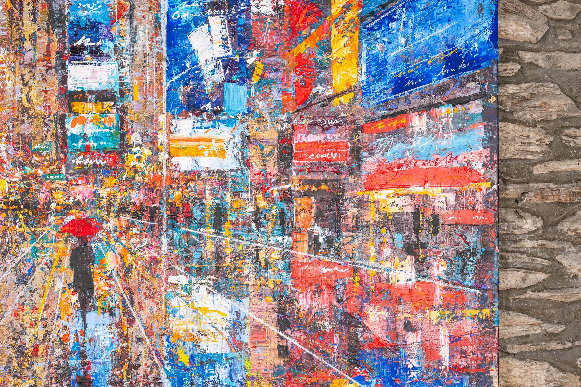 Close-up of Steps Through Times Square, an original painting by Paul Kenton: thick, textured layers of blue, red and gold show neon signs and a figure beneath a red umbrella in the rain.