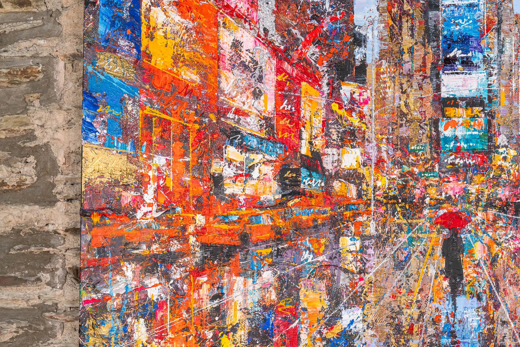 Close-up of Steps Through Times Square, an original mixed media painting by Paul Kenton, showing thick palette-knife texture of red, orange and blue neon signs with a lone figure under a red umbrella.