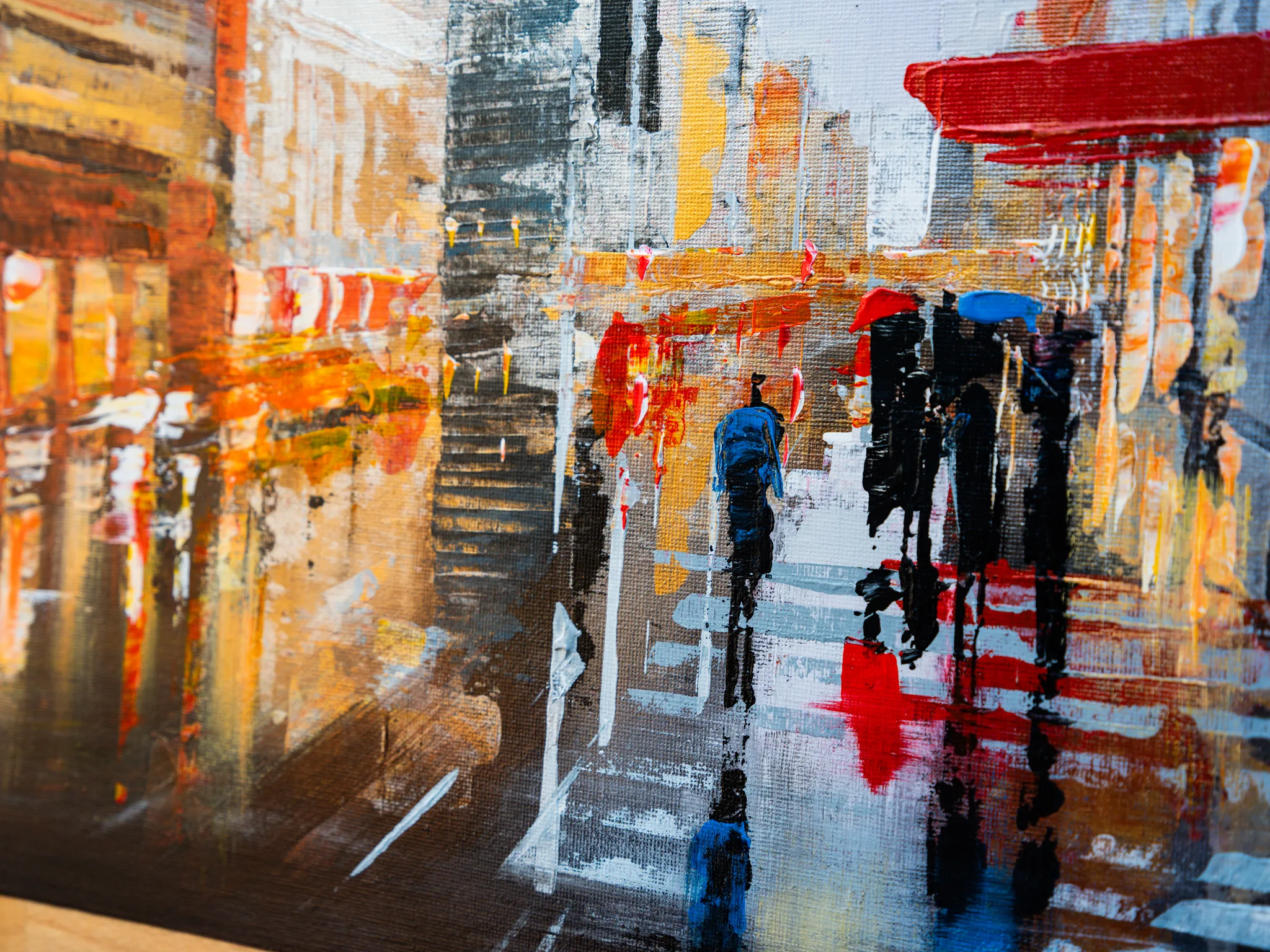 Close-up of Under the Chrysler, an original painting by Paul Kenton, showing thick textured brushwork of a rainy New York street with umbrella-carrying figures crossing in red, orange and grey.