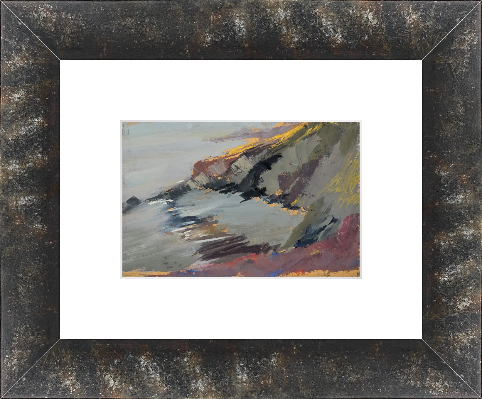 Rugged Coastline, a loose gouache painting of a craggy headland with warm yellow-ochre light on its top edges, grey sea to the left and dark rocks and maroon foreground, set in a dark distressed bronze frame with a white mount.