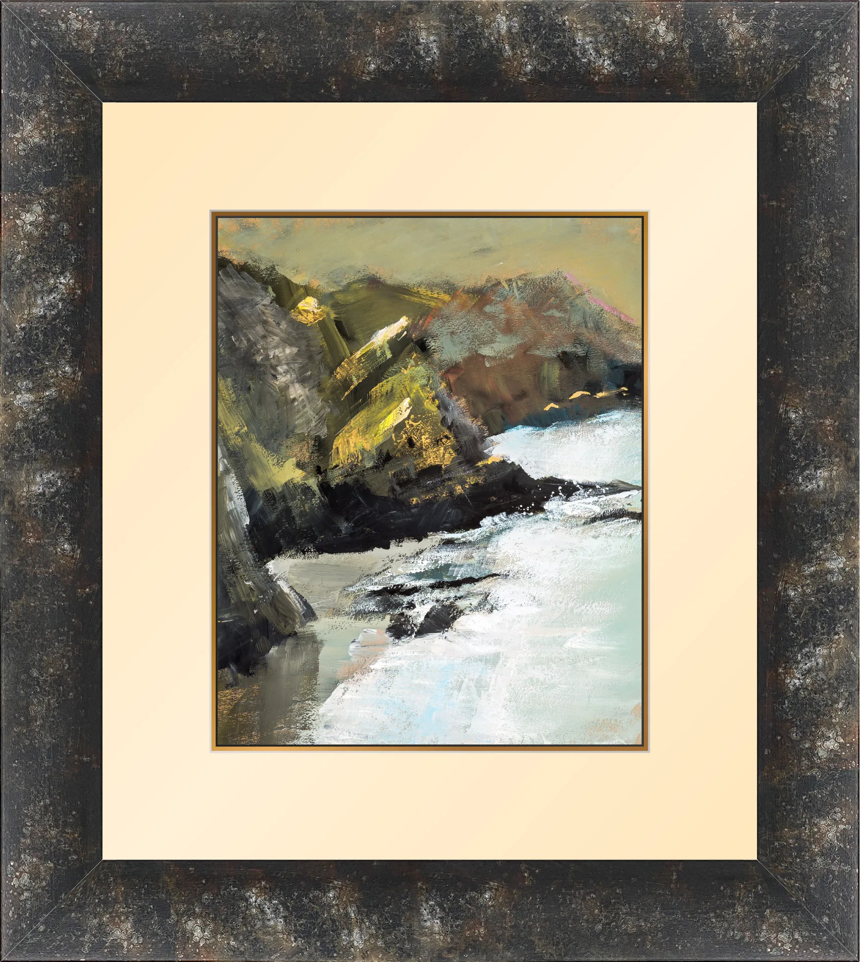 Glistening Rocks, a loose painting of rugged cliffs in olive, ochre and dark brown, with sunlit gold highlights, meeting white-capped surf. The dark, distressed wooden frame surrounds a cream mount.
