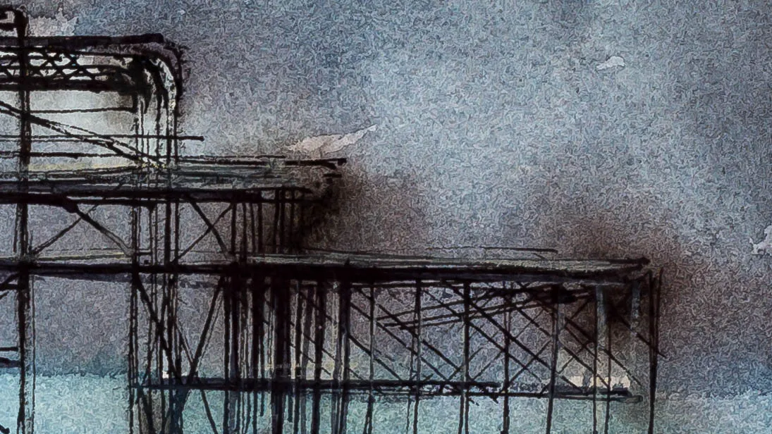 Close-up of Pier Remains, a watercolour and ink painting: dark, scratchy ink lines form the skeletal iron lattice of a pier against a mottled grey-blue wash, with soft brown smudges and pale teal water below.