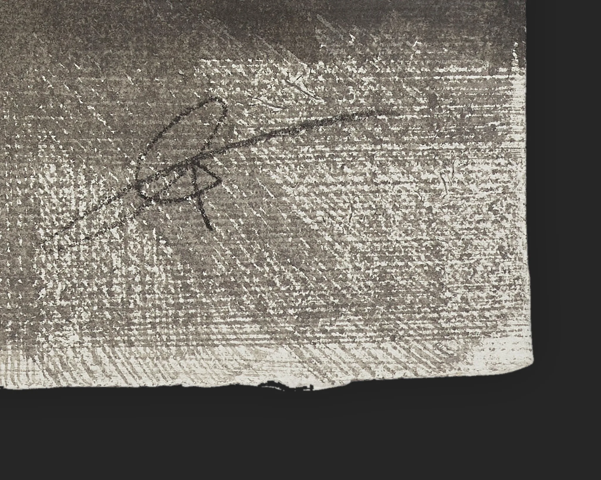 Close-up detail of the bottom corner of Flatiron Illuminated, an original ink painting on Indian paper by Paul Kenton, showing his hand-drawn signature in dark ink over fine, grainy grey-brown textured marks.