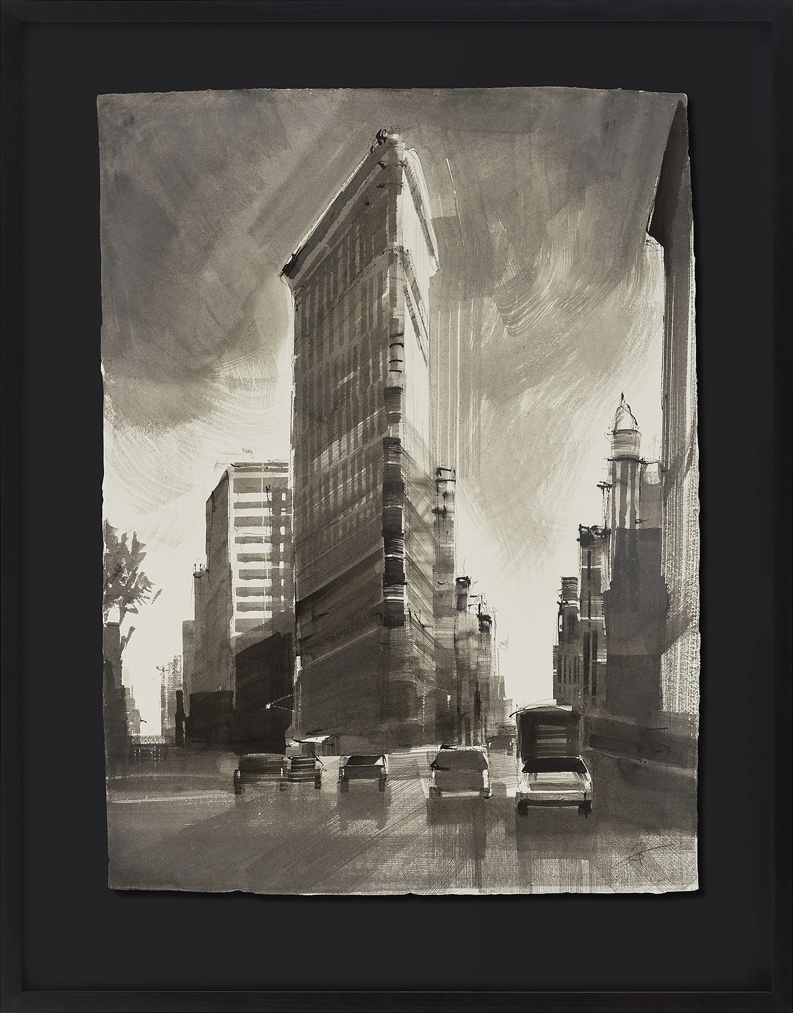 Flatiron Illuminated, an original ink on Indian paper painting by Paul Kenton, shown in a black frame: the triangular Flatiron Building rises in grey washes beside cars on a New York street under a brooding sky.