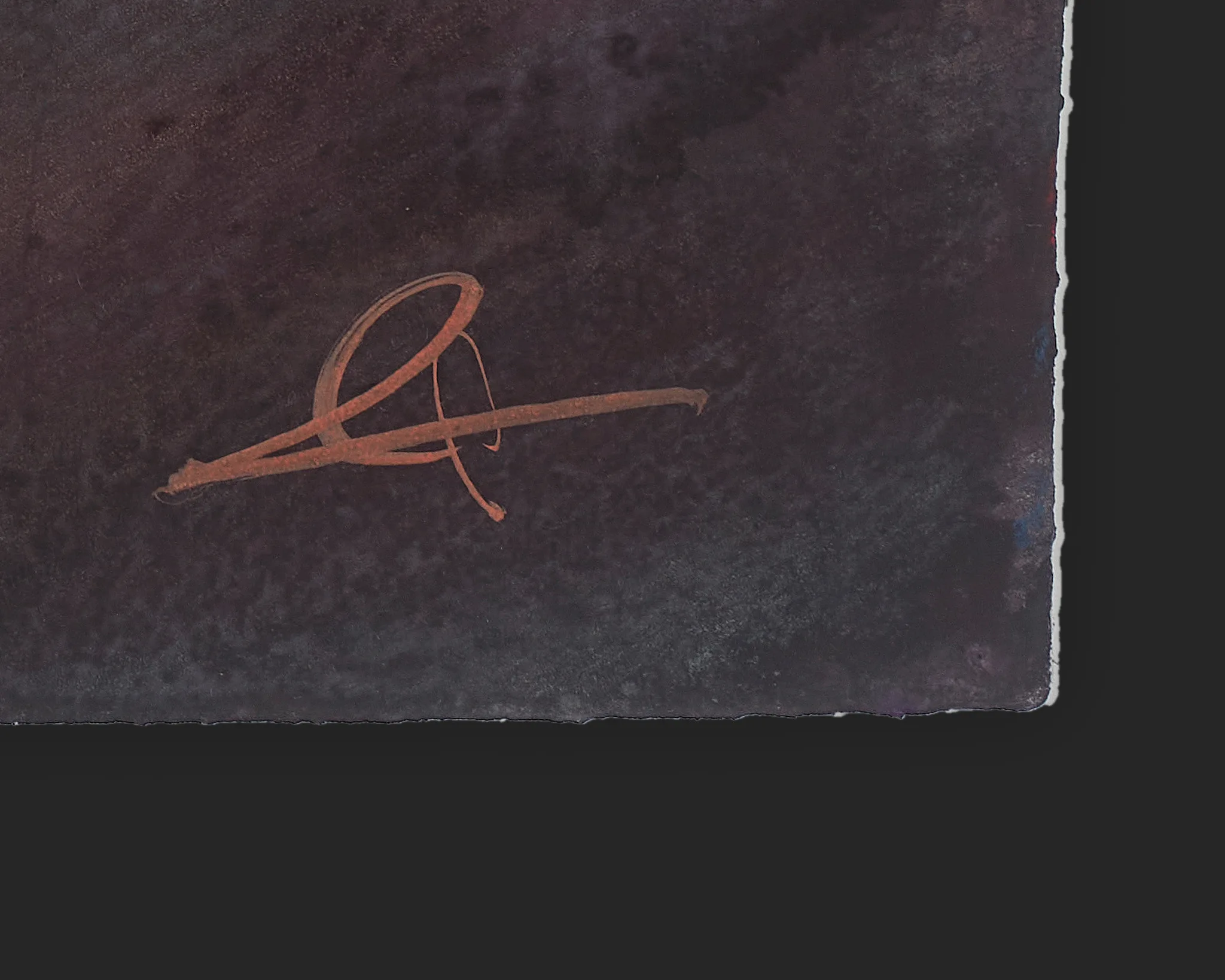 Close-up of the bottom corner of Glow on the Avenue, an original painting by Paul Kenton, showing his signature in rust-orange paint on a dark, mottled plum-brown ground with deckled paper edges.