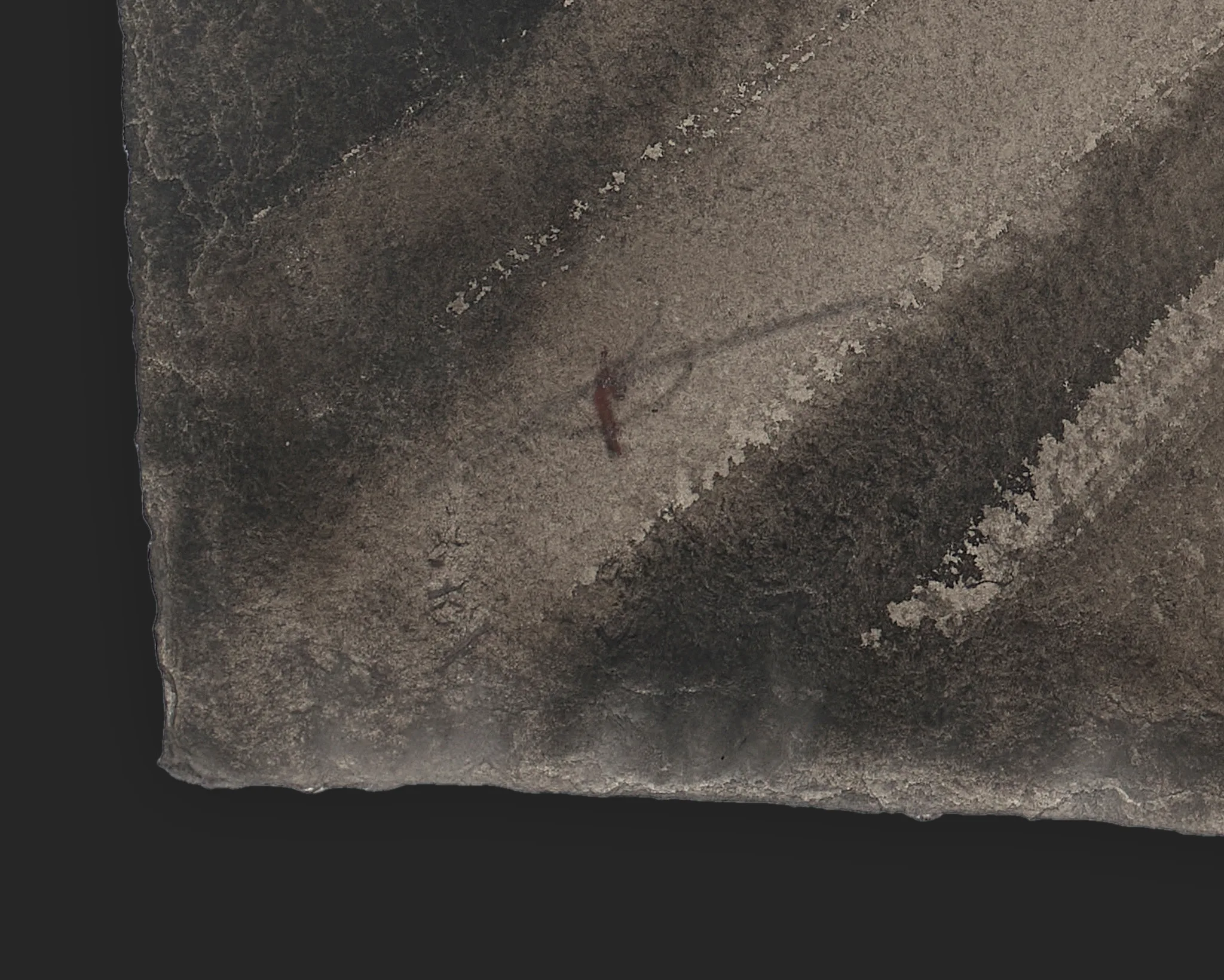 Close-up detail of City in Transit, an original ink and charcoal painting on Indian paper by Paul Kenton: grey and brown diagonal smudges with textured, flecked edges and a small dark mark at centre.