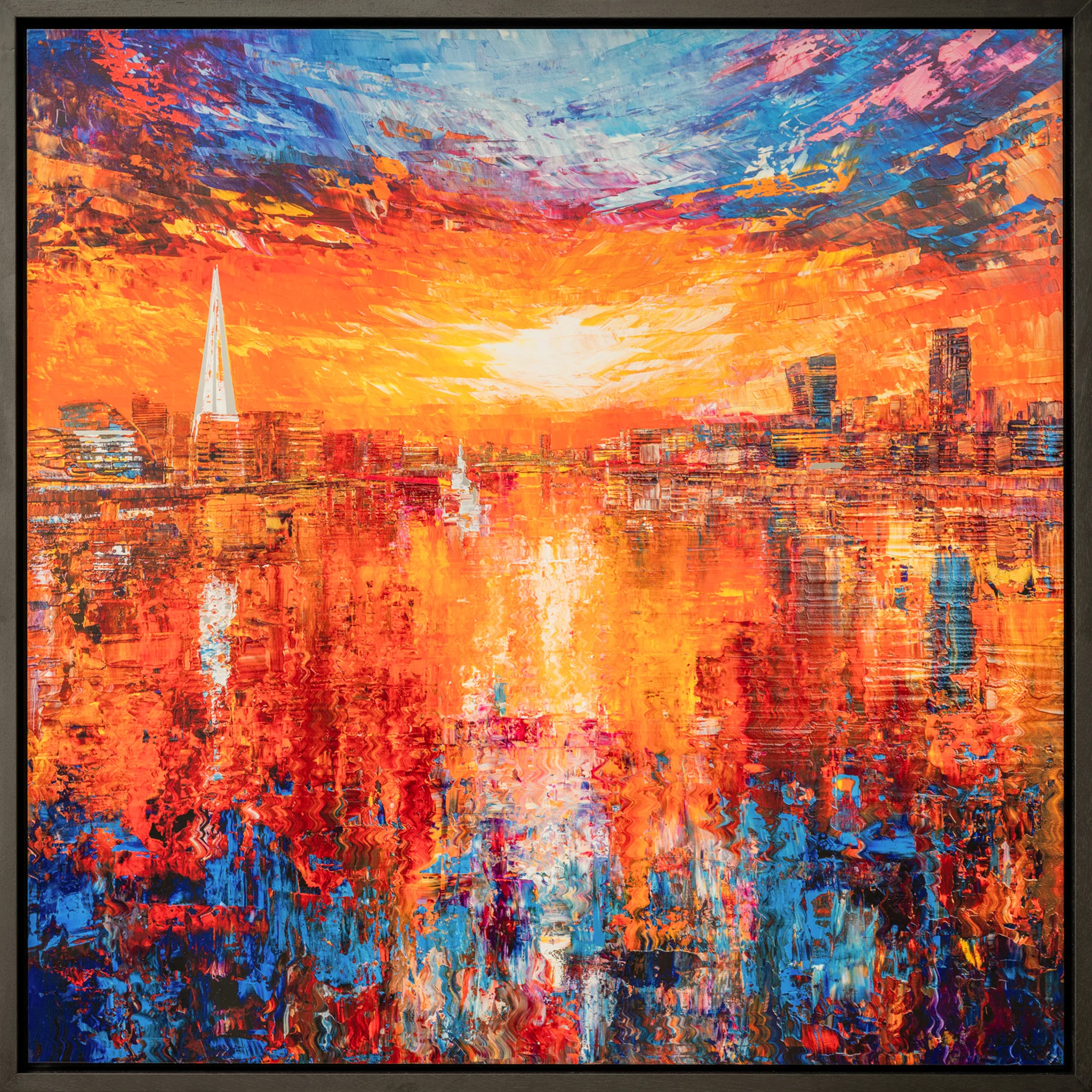 Currents of Light, a limited edition print by Paul Kenton in a dark slim frame: a London riverside sunset in bold orange, red and blue, with a tall spire on the left and reflections rippling across the water.