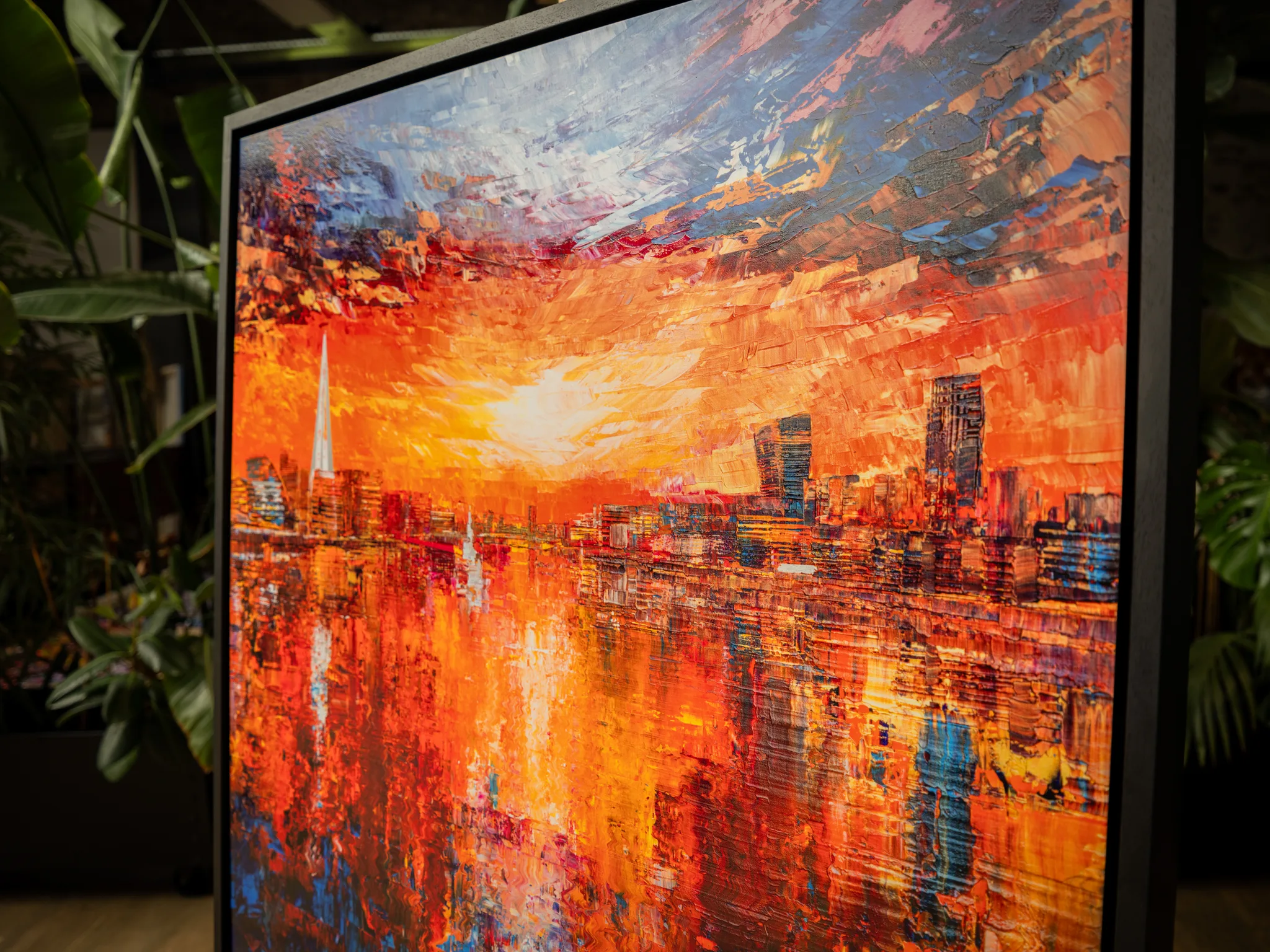 Detail of Currents of Light, a limited edition print of London, showing a glowing orange sunset over the river, a tall spire and towers, with thick, textured brushstrokes.