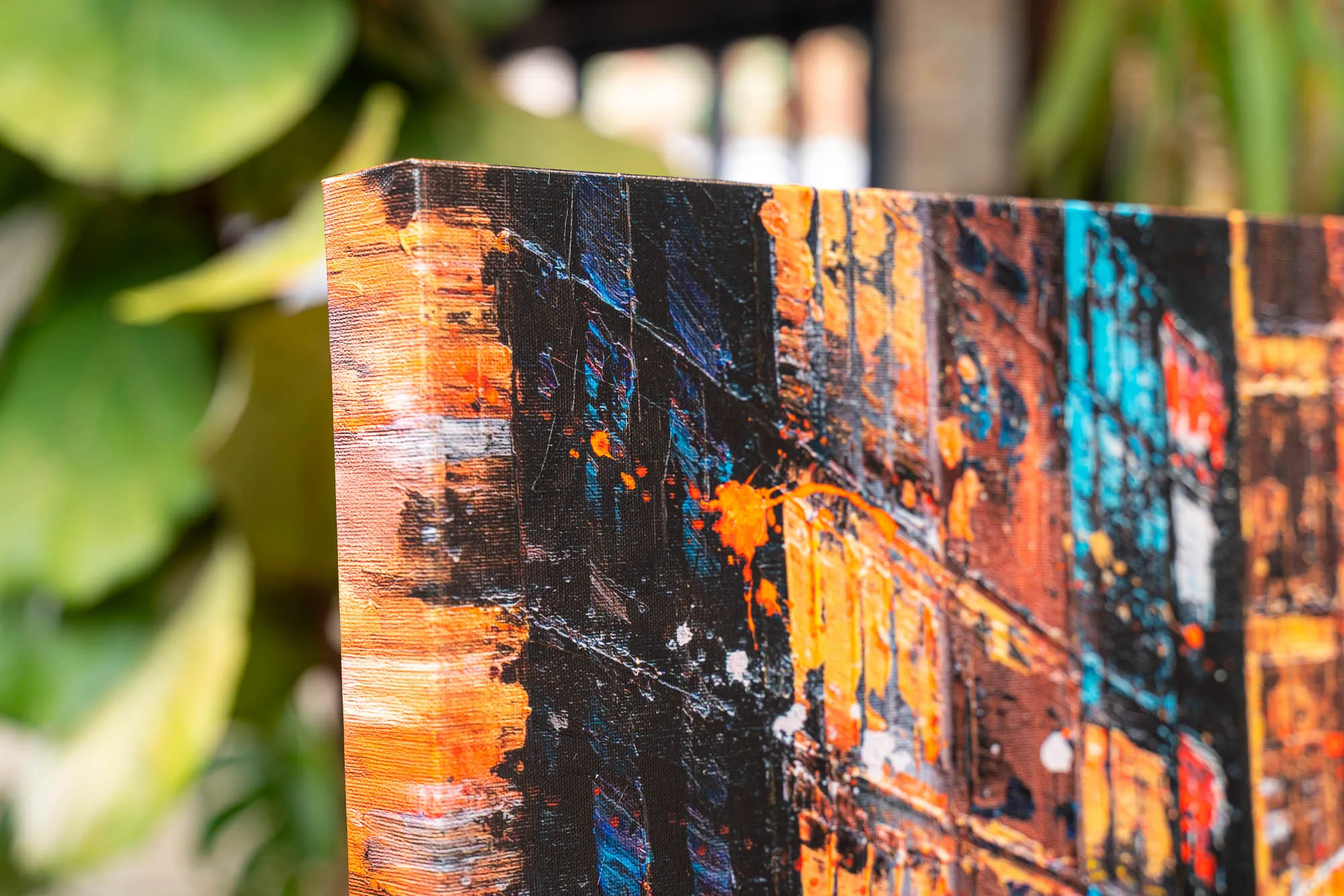Close-up of Downtown Reflections, a limited edition giclée print on boxed canvas by Paul Kenton, showing thick orange, black and teal textured strokes suggesting city buildings at night.