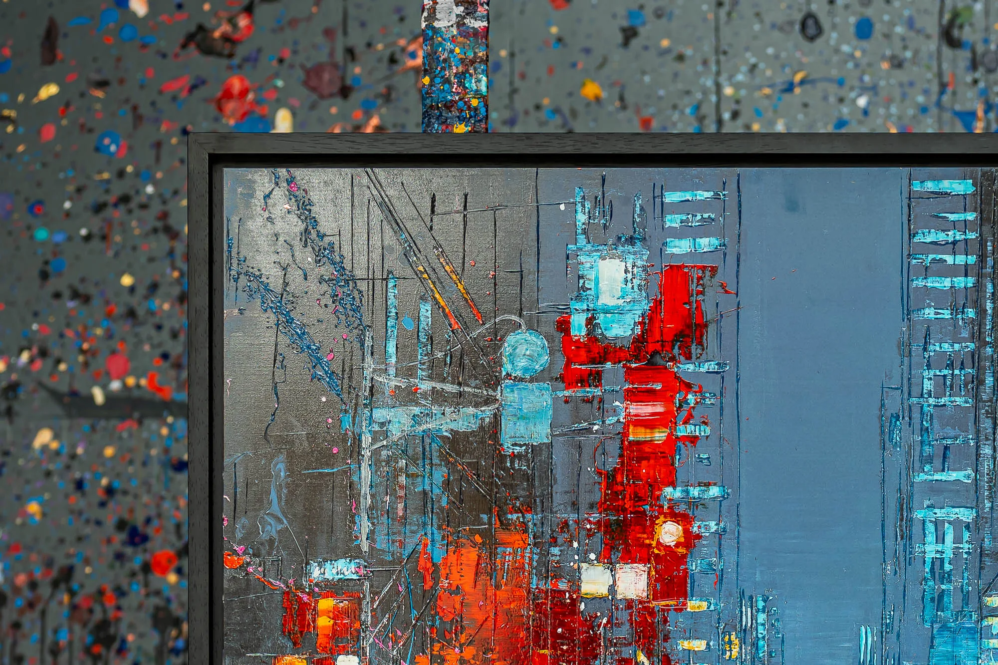 Close-up of Electric Crossroads, a limited edition print by Paul Kenton, showing a textured city scene of grey and blue towers with bold red and orange streaks and glowing turquoise windows.