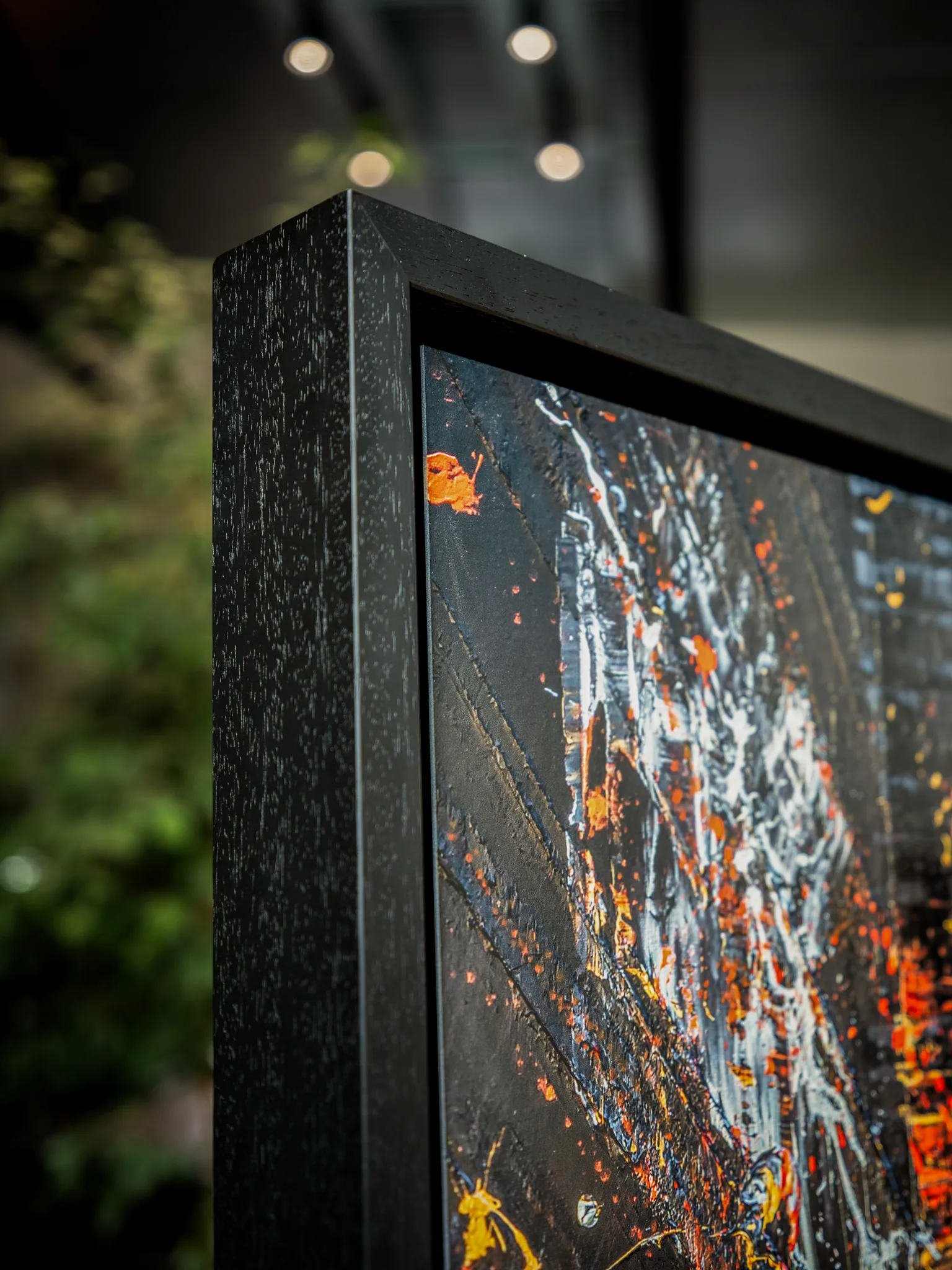 Close-up of Flight of the Taxis, a limited edition print by Paul Kenton, showing black, white and orange splashes with raised texture in a dark wooden frame.