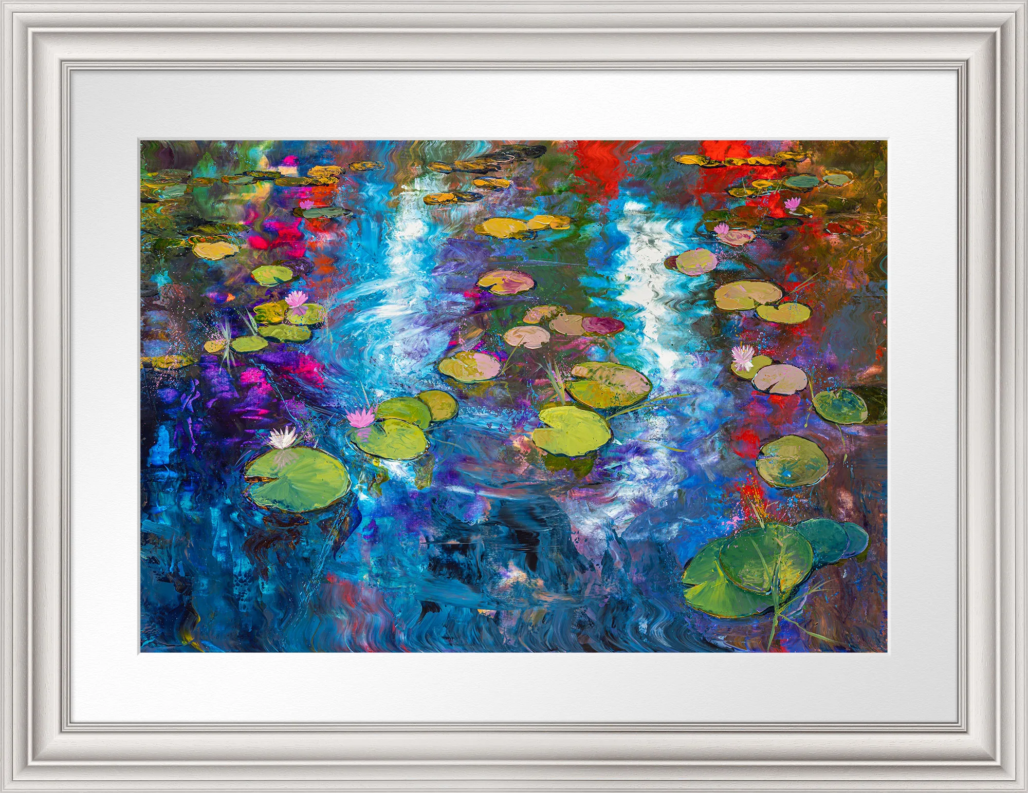 Lily Light, a framed limited edition print by Paul Kenton, in a silver-grey frame with a white mount. Lily pads and pink blooms float on a rippling pond streaked with blue, violet, red and gold.