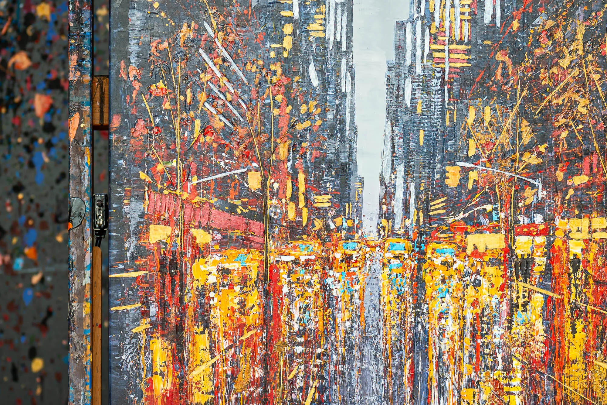 Close-up of New York Serenade, a limited edition embellished giclée print by Paul Kenton, showing thick textured streaks of orange, yellow and red over a grey city street with glowing traffic.