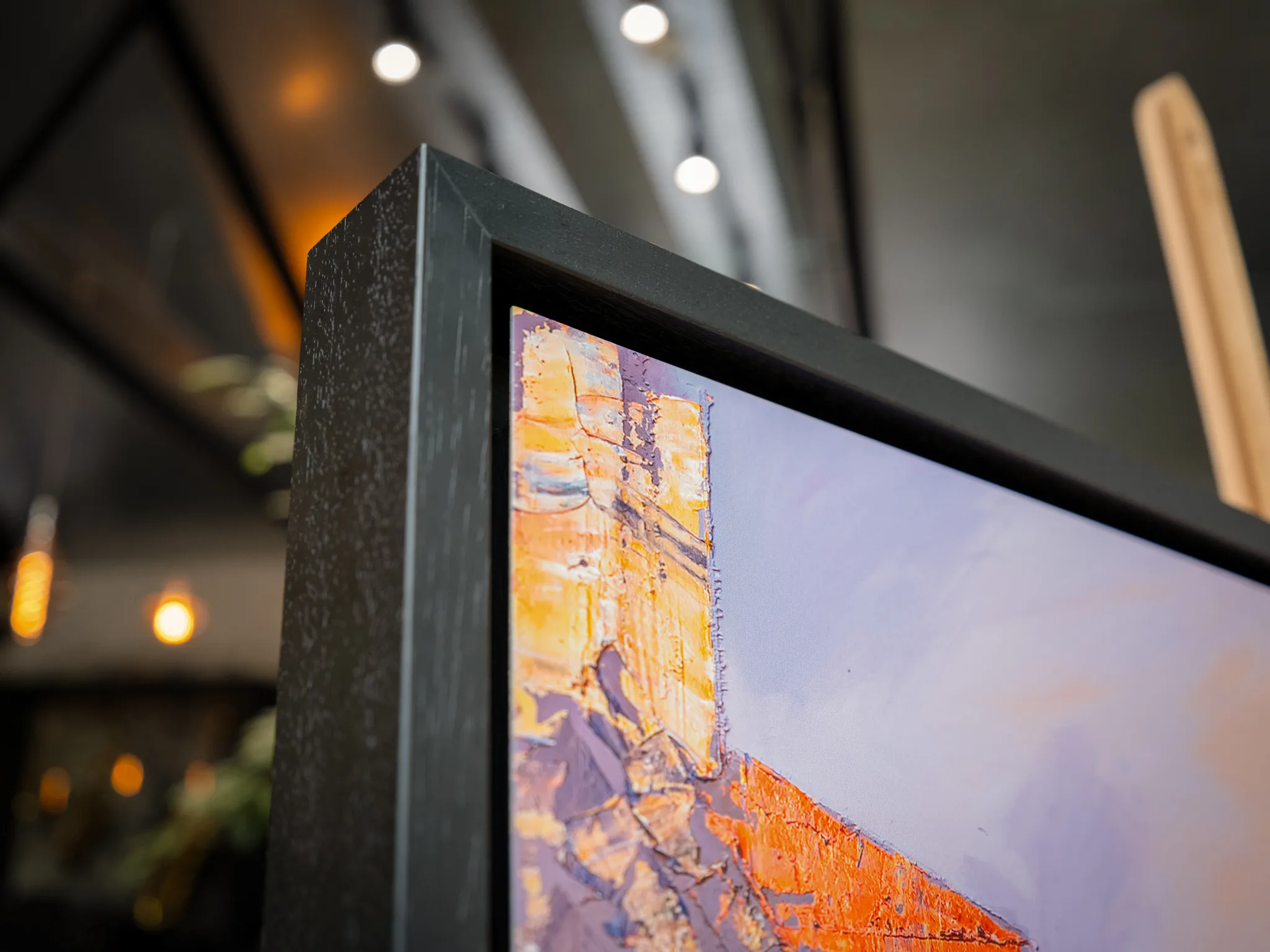 Close-up of Opalescent Venice, a limited edition print by Paul Kenton, showing thick golden and orange textured strokes on a building against a lavender sky, in a dark grey frame.