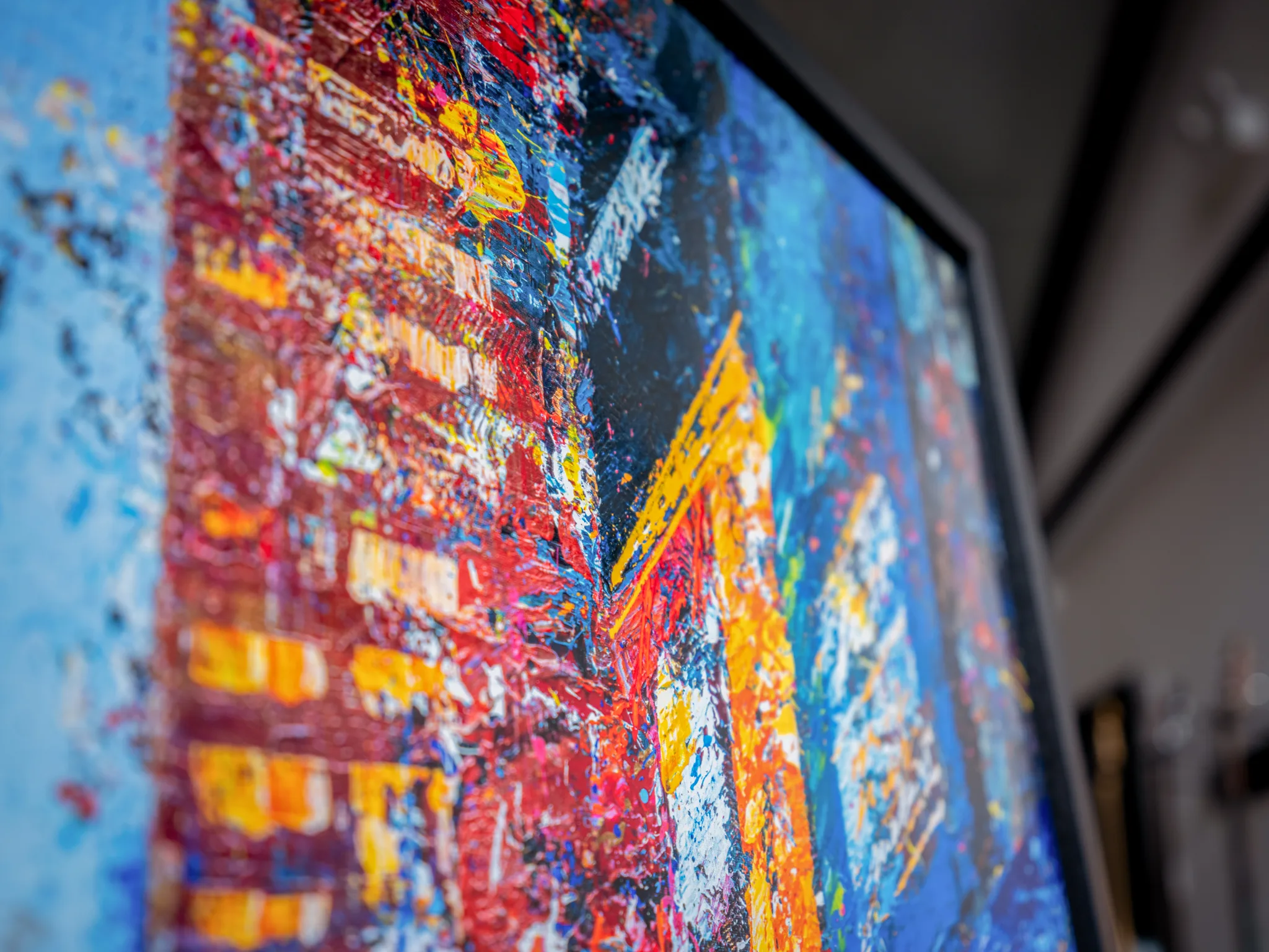 Close-up of Steps Through Times Square, a limited edition print by Paul Kenton, showing thick red, yellow and blue textured paint ridges suggesting bright city lights and buildings.