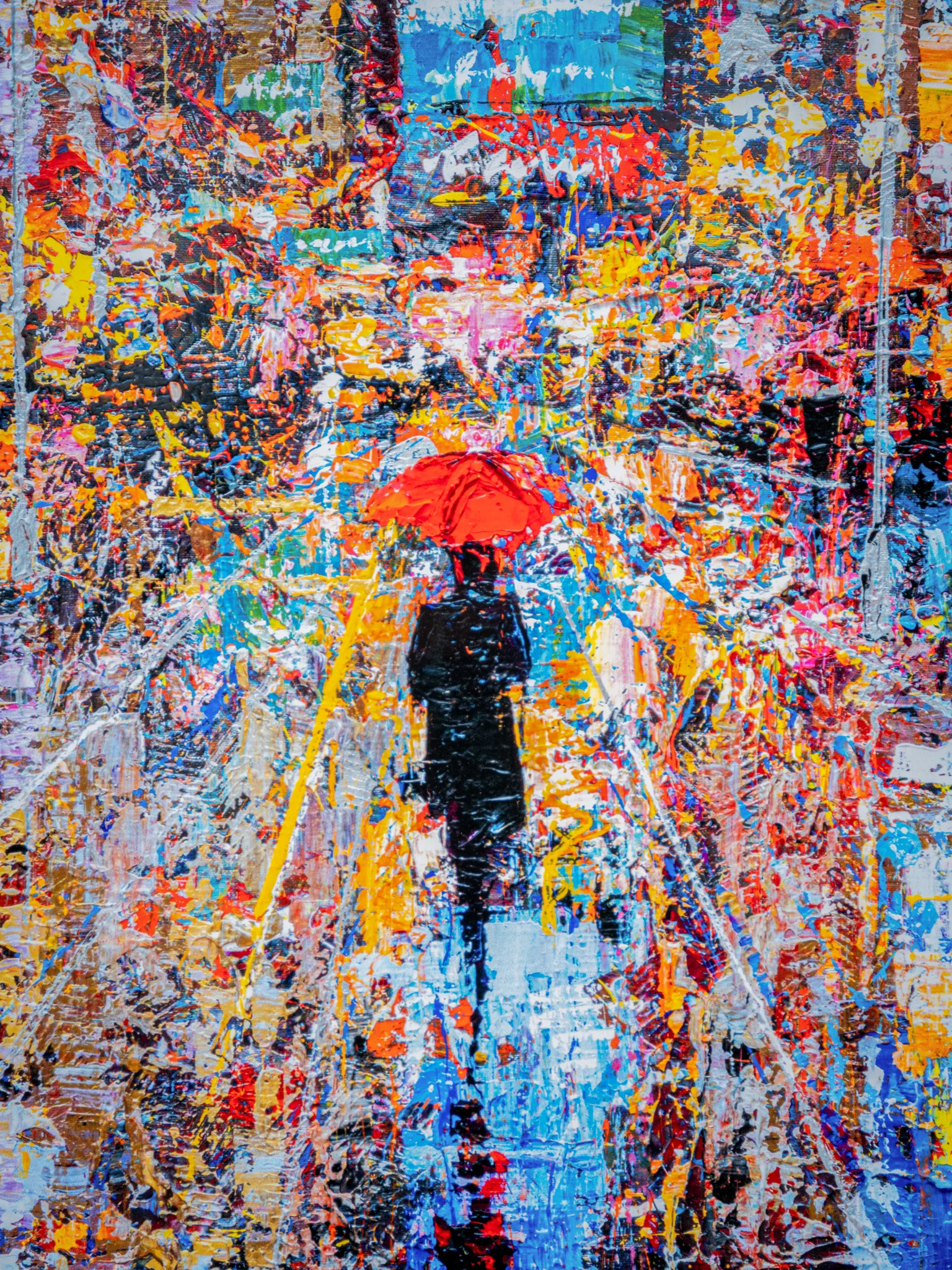 Detail of Steps Through Times Square, an embellished giclée print by Paul Kenton: a dark figure under a bright red umbrella walks a blue street amid thick, textured splashes of orange, yellow and pink.