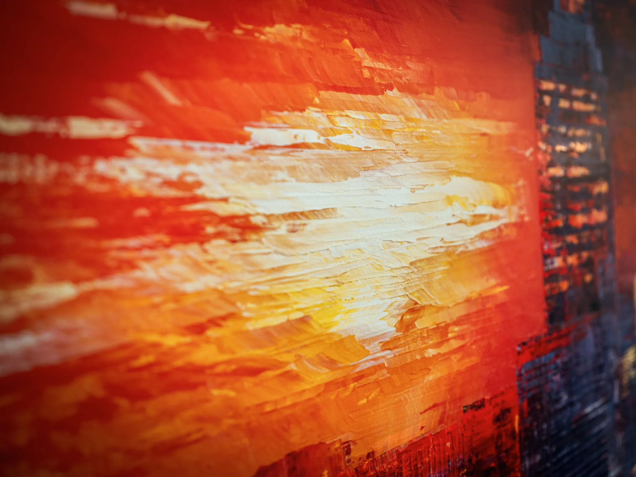 Close-up of Urban Approach, a limited edition print by Paul Kenton, showing thick textured strokes of red, orange and gold blazing across the sky beside a dark, lit skyscraper.
