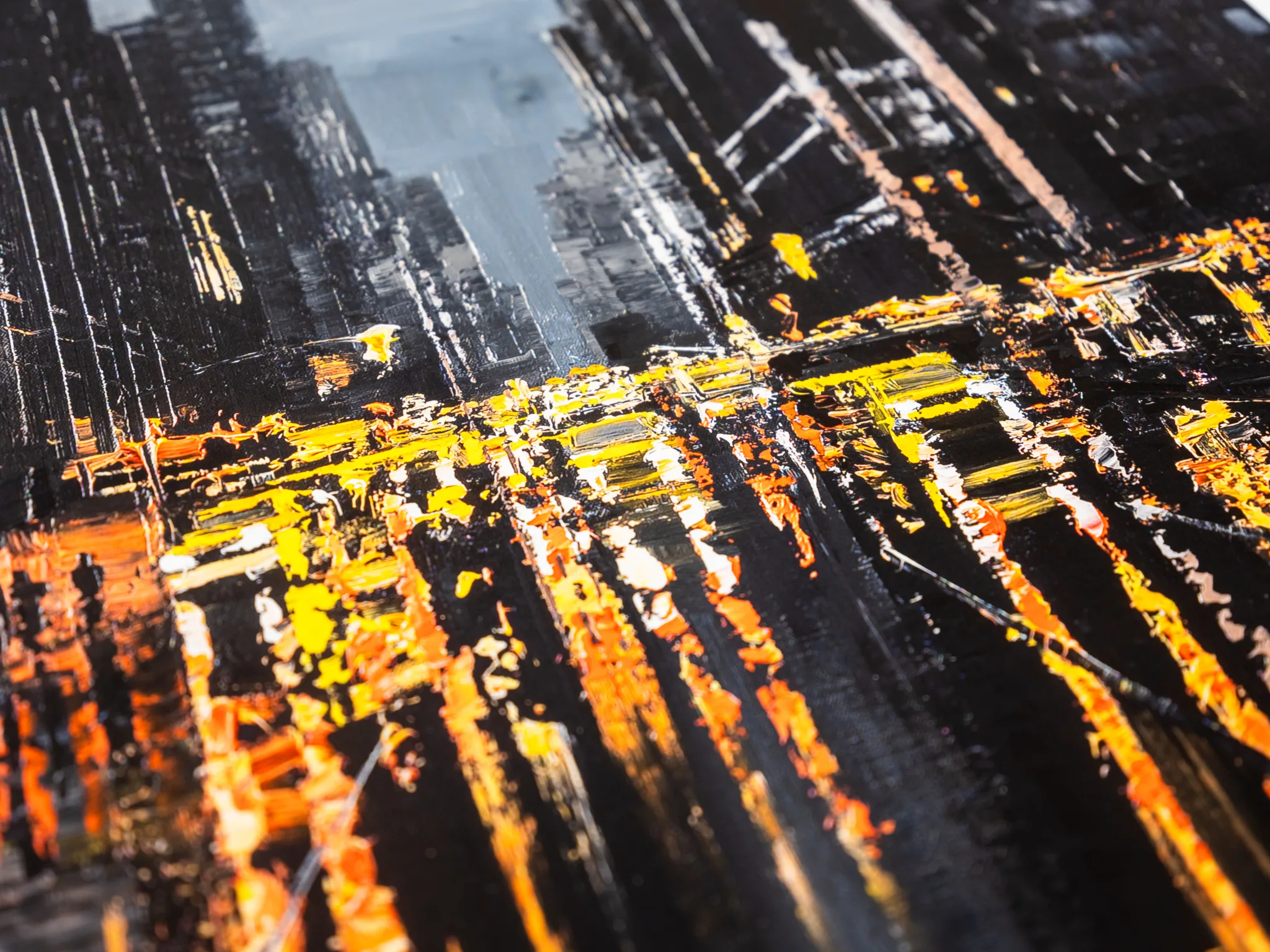 Close-up of Manhattan Glow, a limited edition giclée print by Paul Kenton, showing thick textured brushstrokes of yellow, orange and white light cutting through near-black city towers.