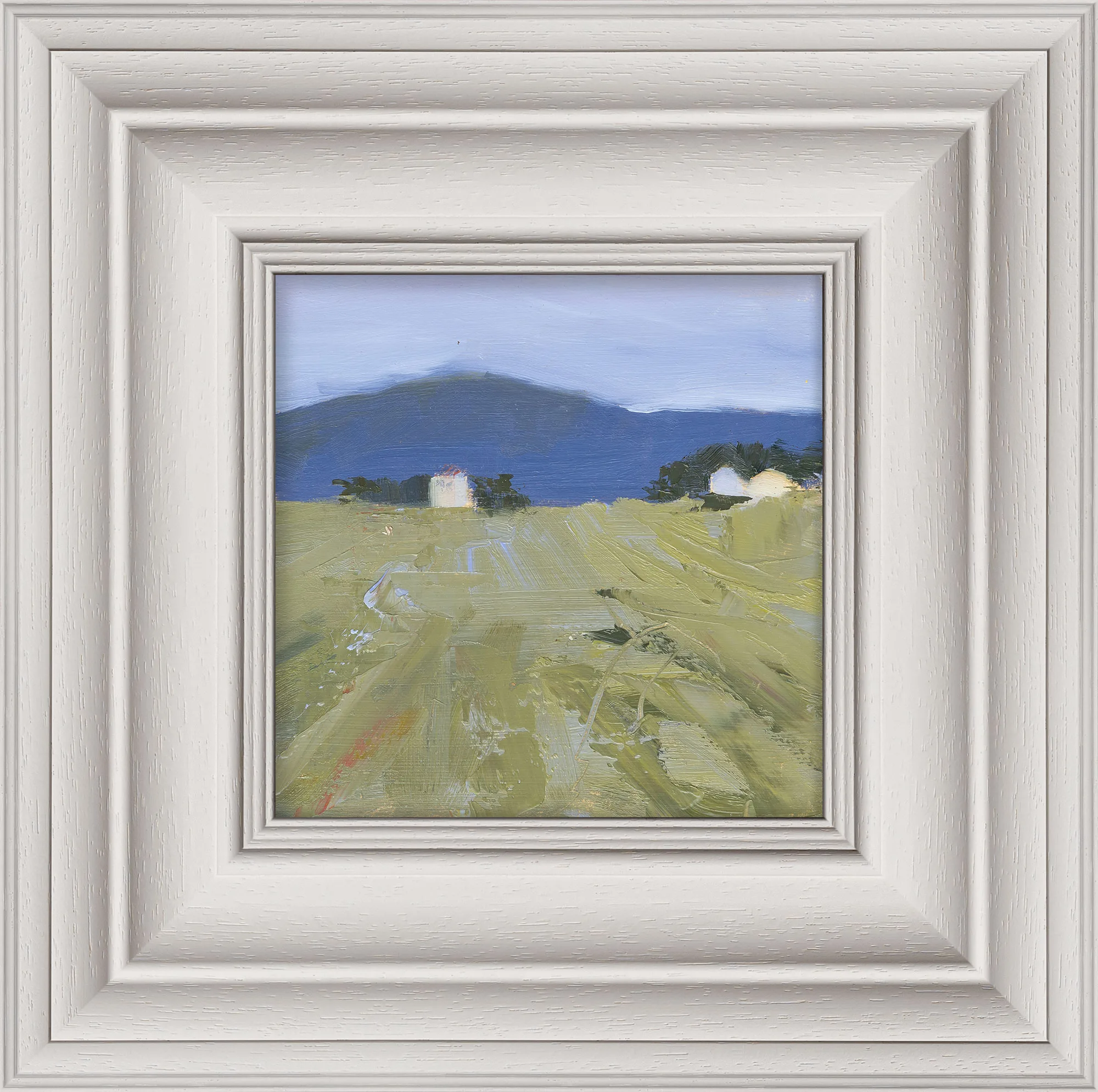 Italian Escape, an original oil painting by Paul Kenton in a wide cream frame: a loose green field of rough brushstrokes leads to two white houses and a dark blue mountain under a pale sky.