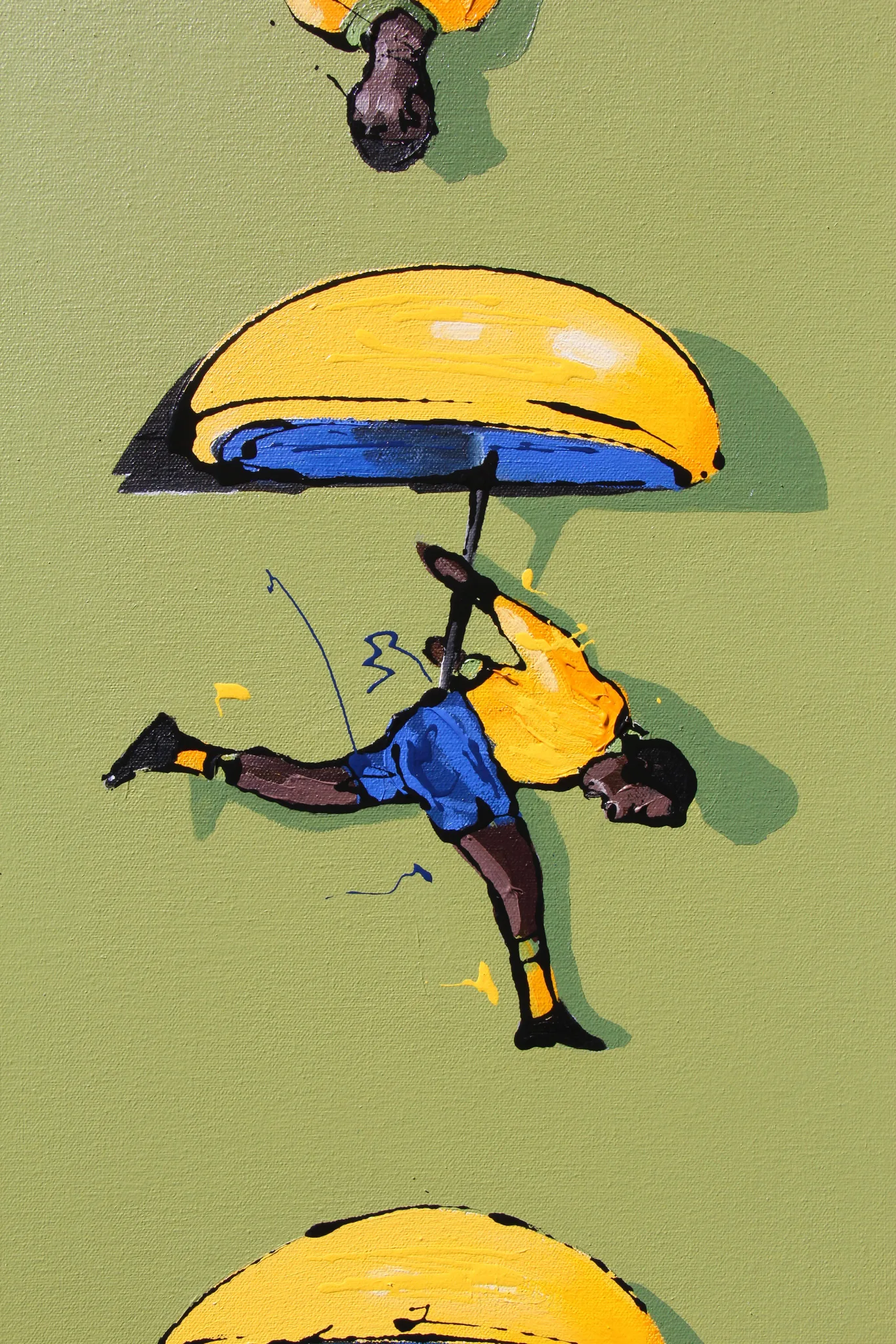 Detail from another of the Pelé works: a small painted footballer in yellow and blue hanging beneath a yellow dome like a parachute, on green